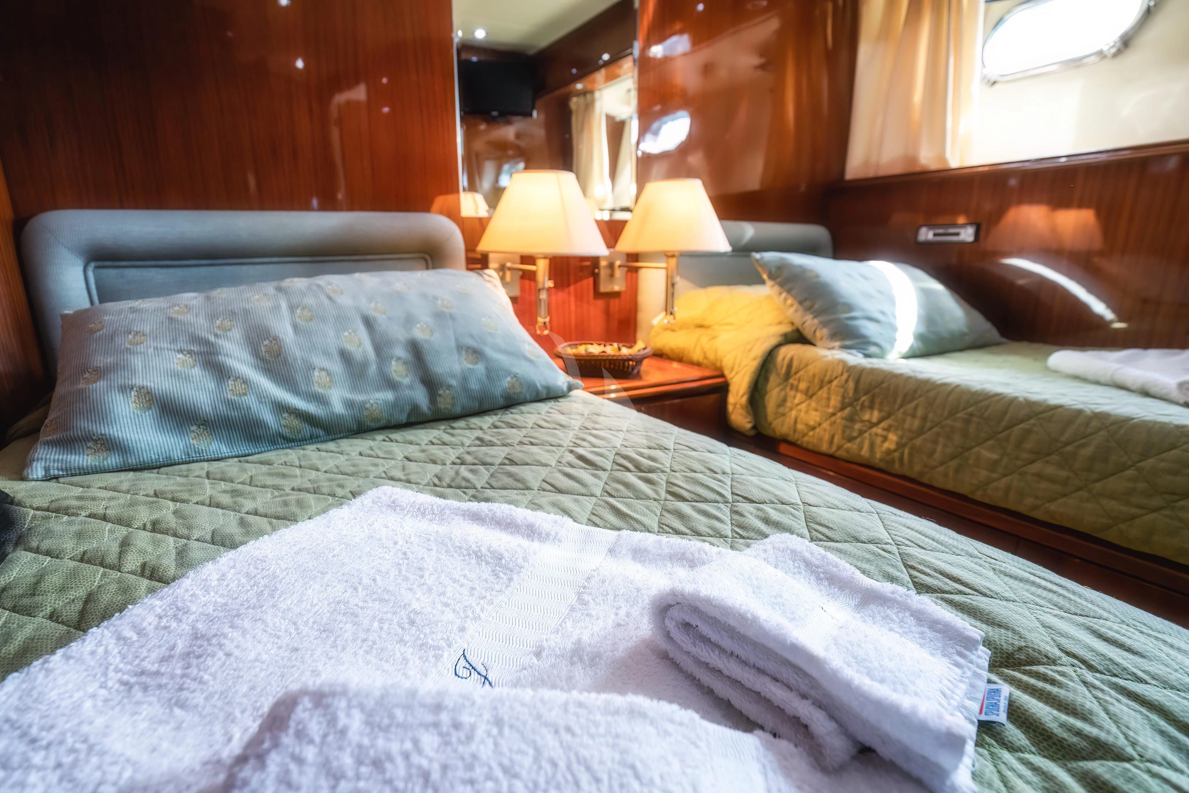 a couple of beds in a hotel room aboard JAUNI Yacht for Sale