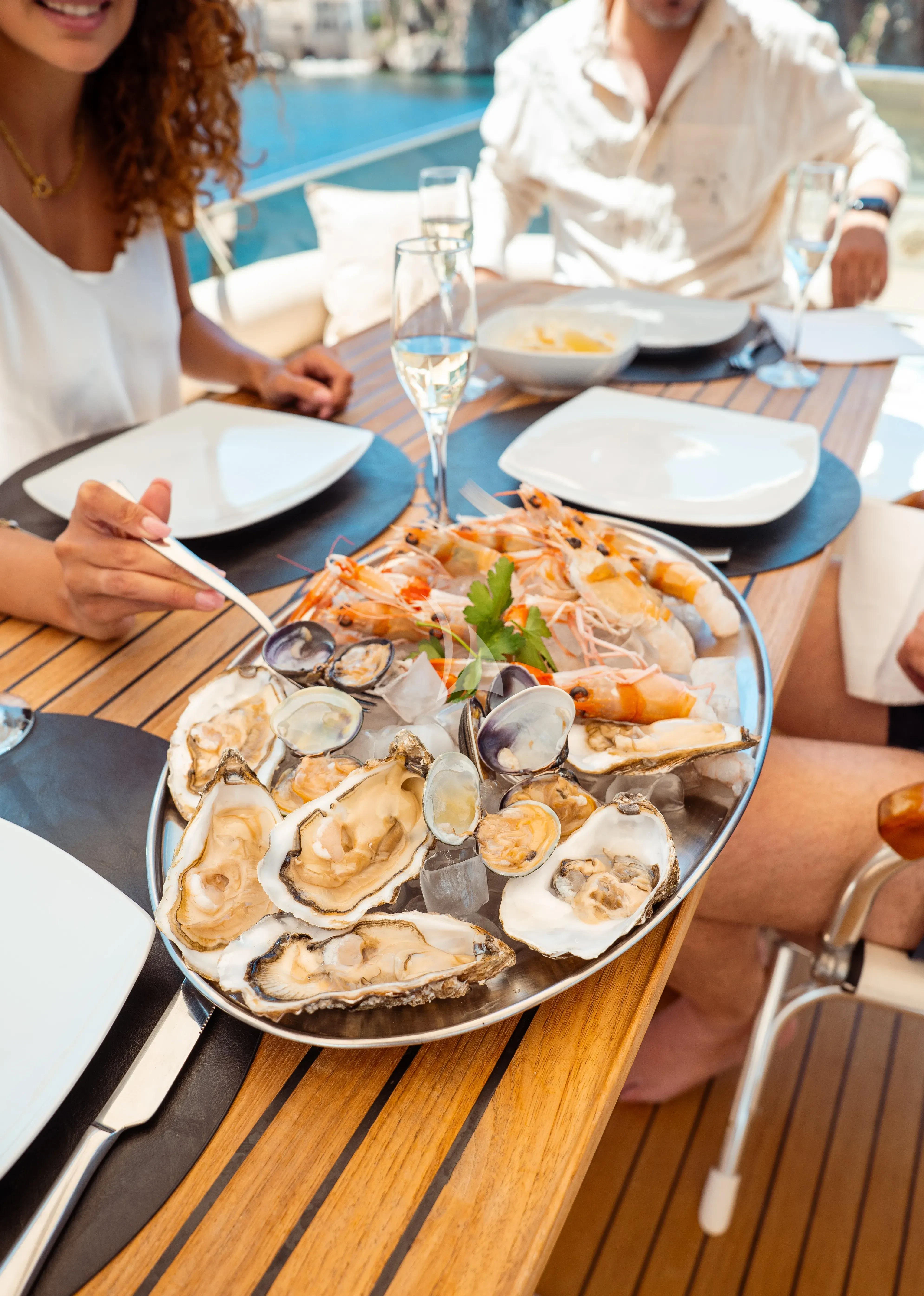 a person sitting at a table with a plate of food aboard JAUNI Yacht for Sale