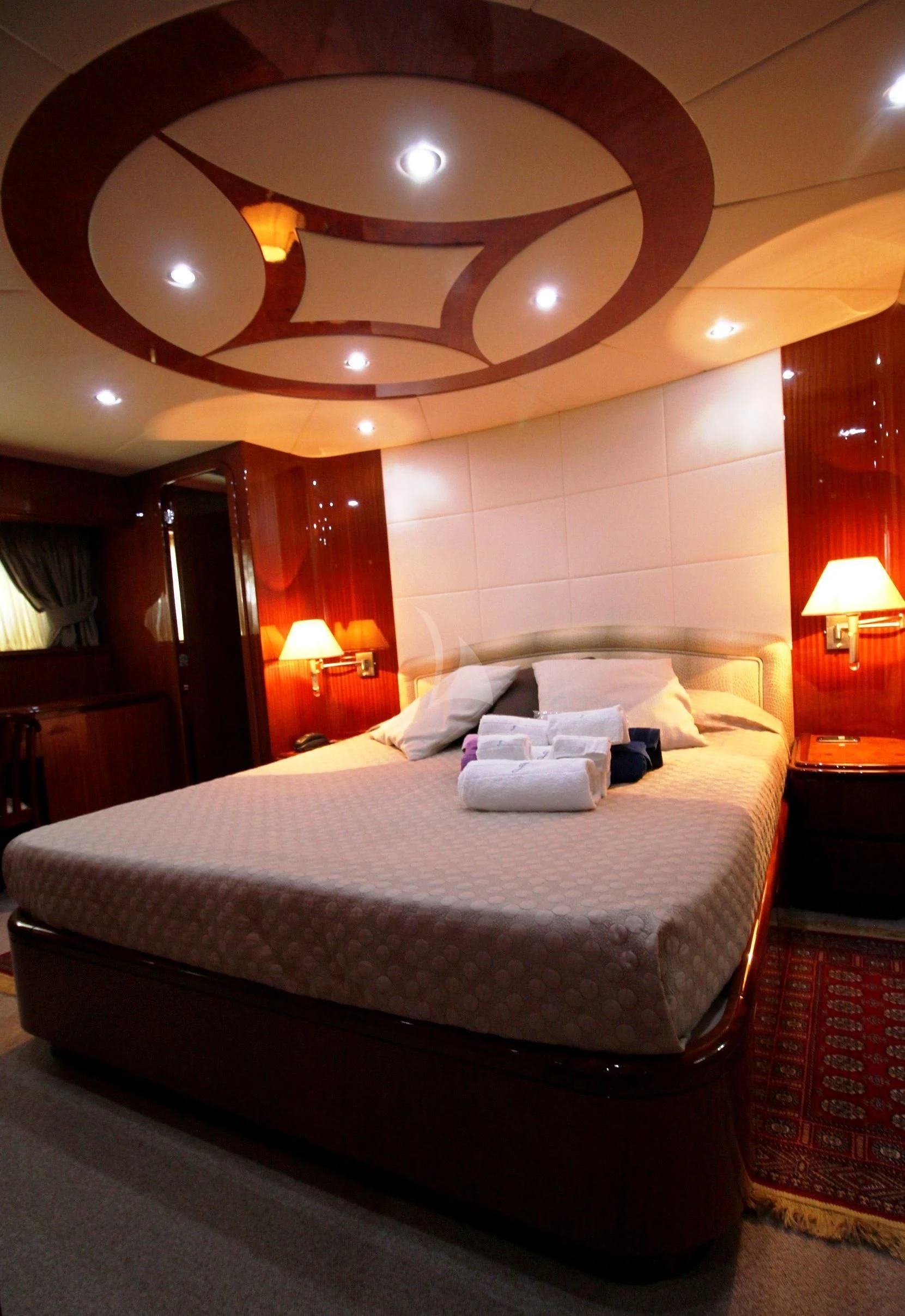 a bed with a large mirror above it aboard JAUNI Yacht for Sale