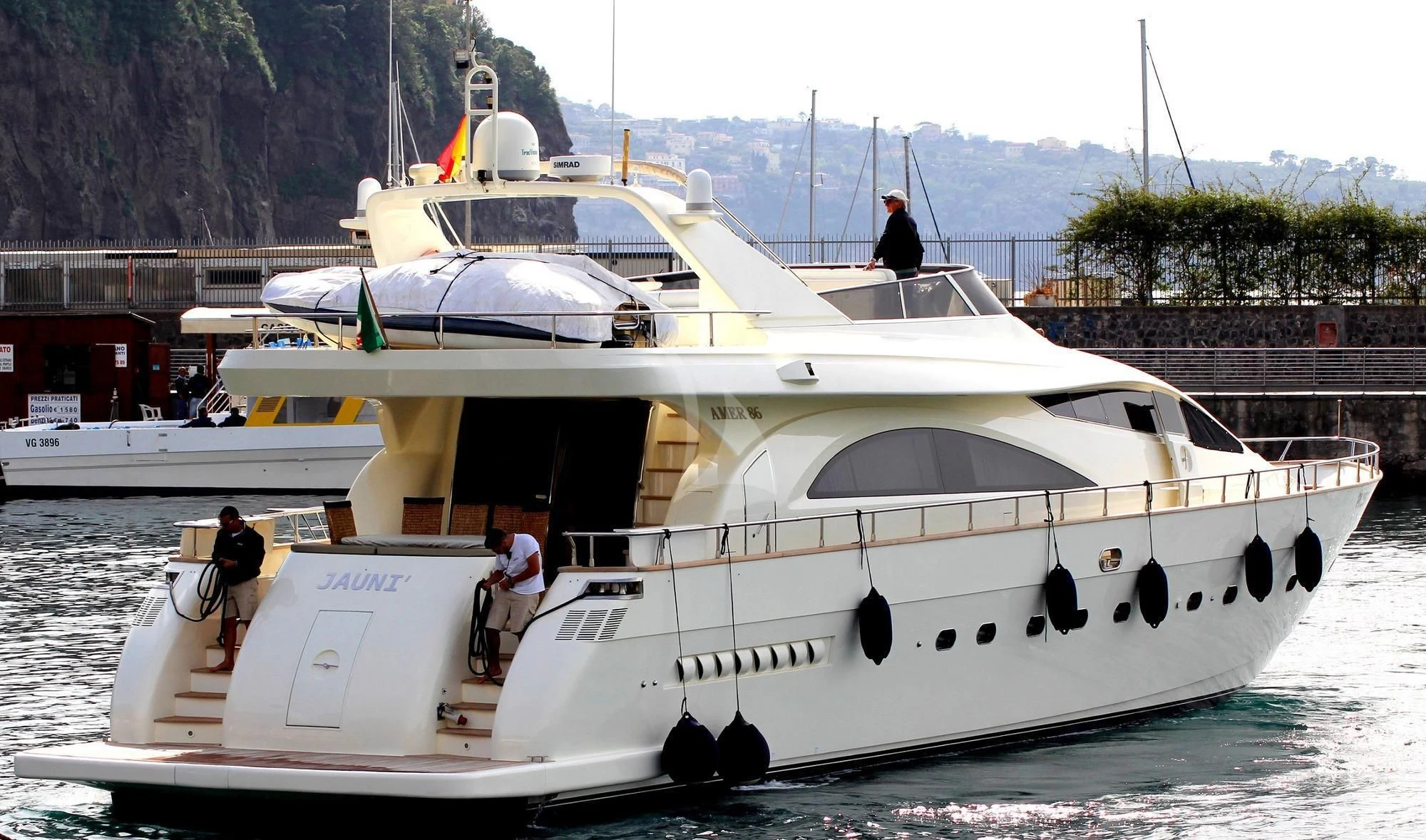 a white boat with people on it aboard JAUNI Yacht for Sale