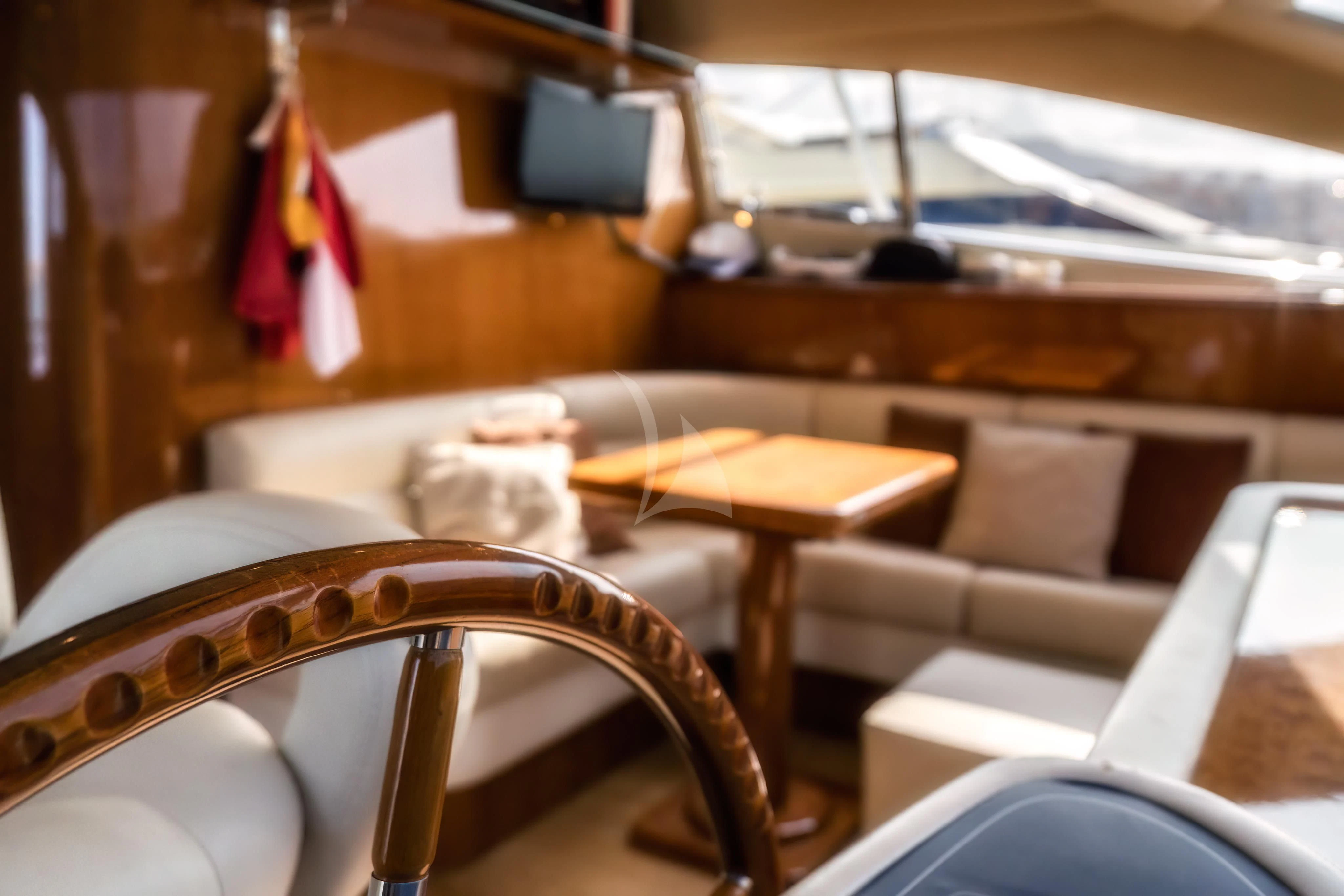 a room with a bed and chairs aboard JAUNI Yacht for Sale