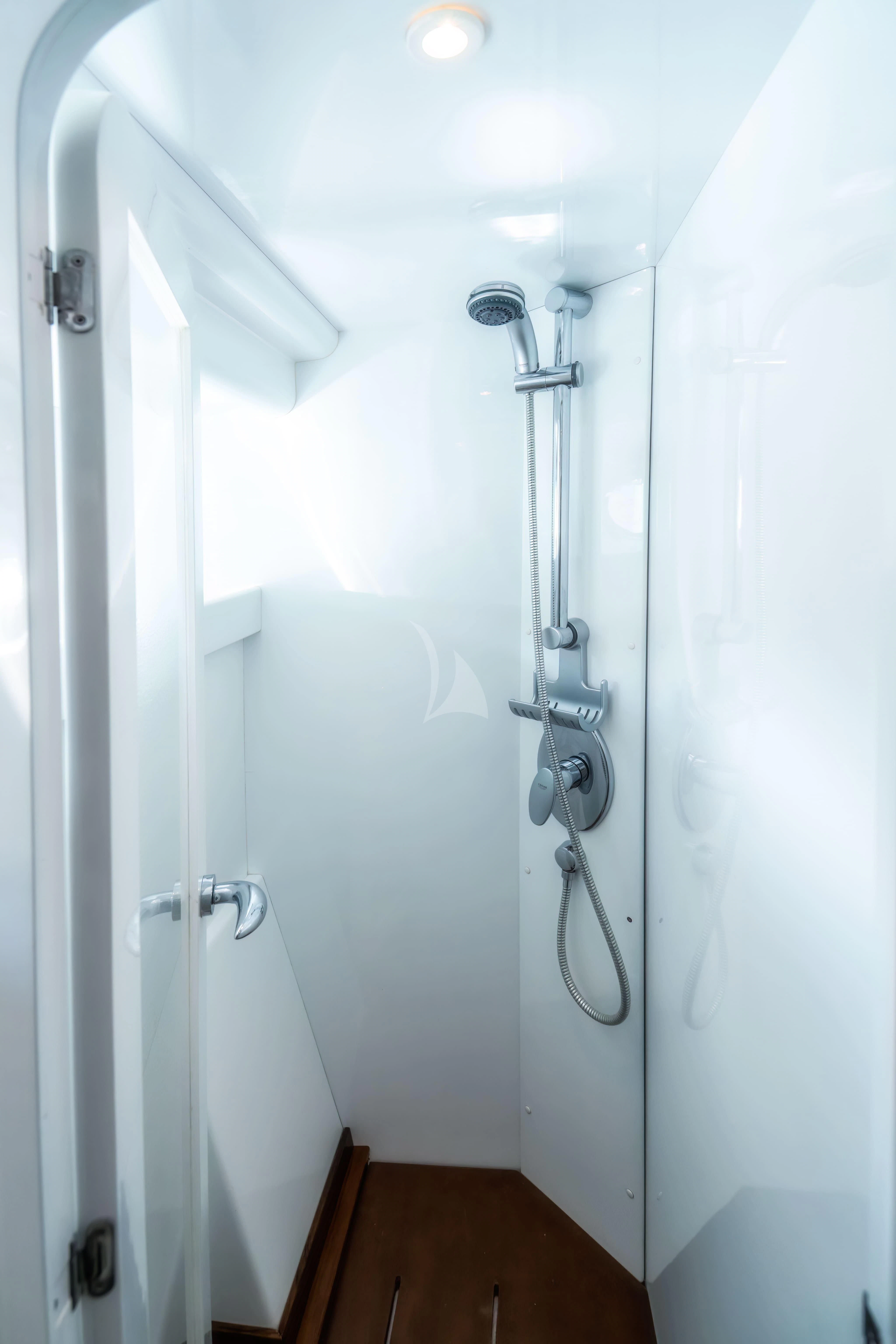 a white door with a shower head aboard JAUNI Yacht for Sale