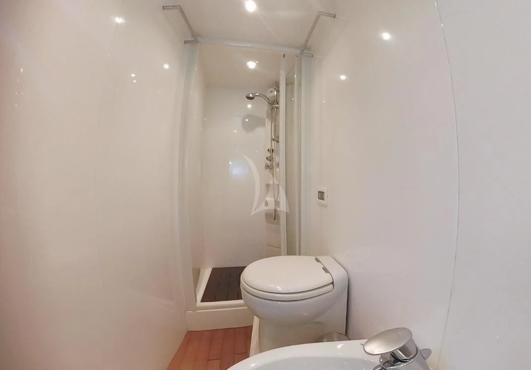 a bathroom with a toilet and shower aboard JAUNI Yacht for Sale
