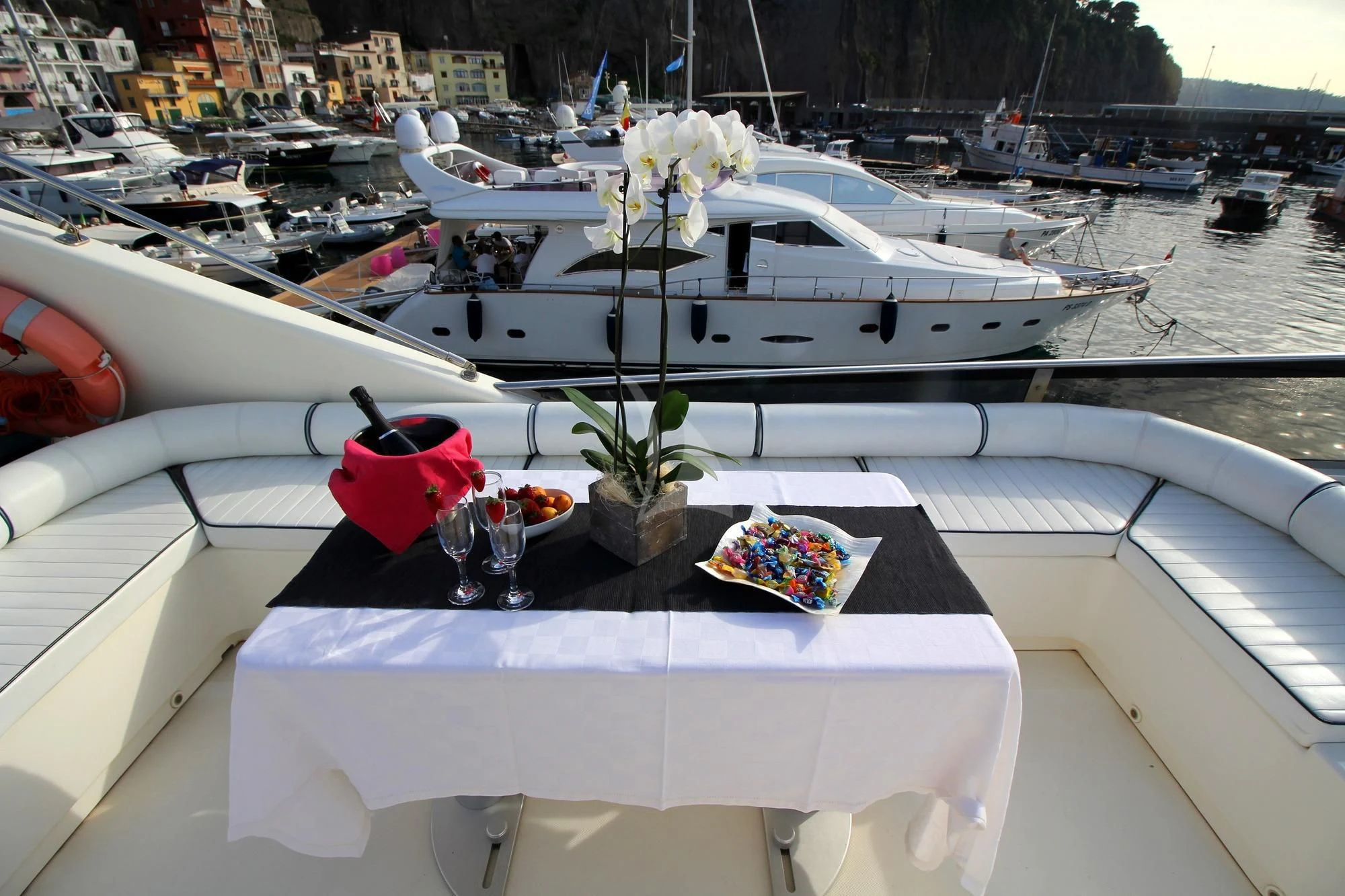 a white boat with a white flower on it aboard JAUNI Yacht for Sale