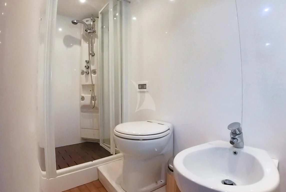 a bathroom with a sink toilet and shower aboard JAUNI Yacht for Sale