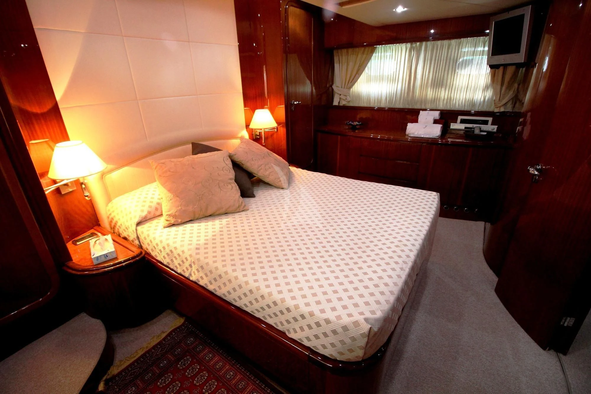 a bedroom with a bed and desk aboard JAUNI Yacht for Sale