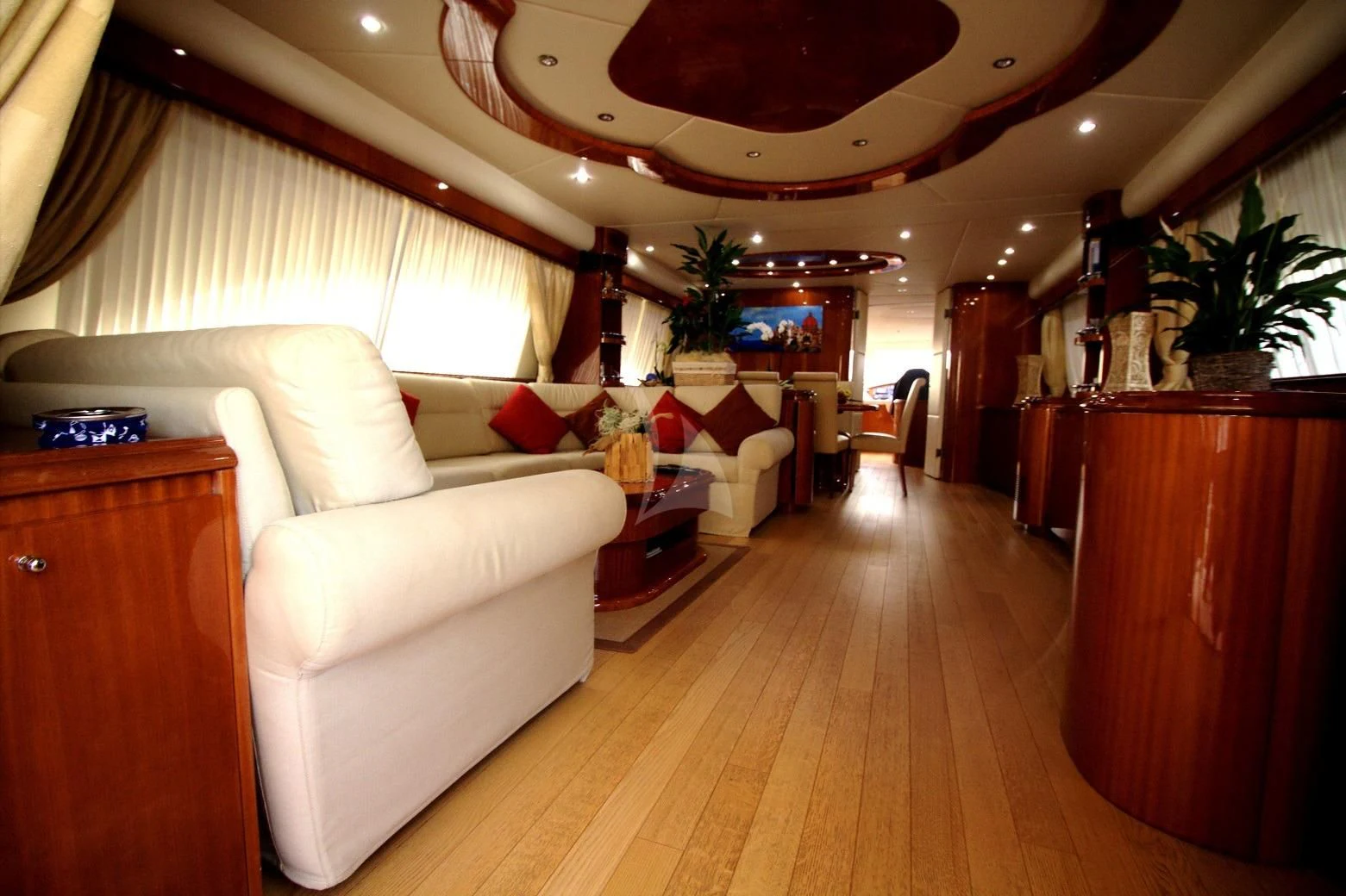 a living room with a large wood floor aboard JAUNI Yacht for Sale