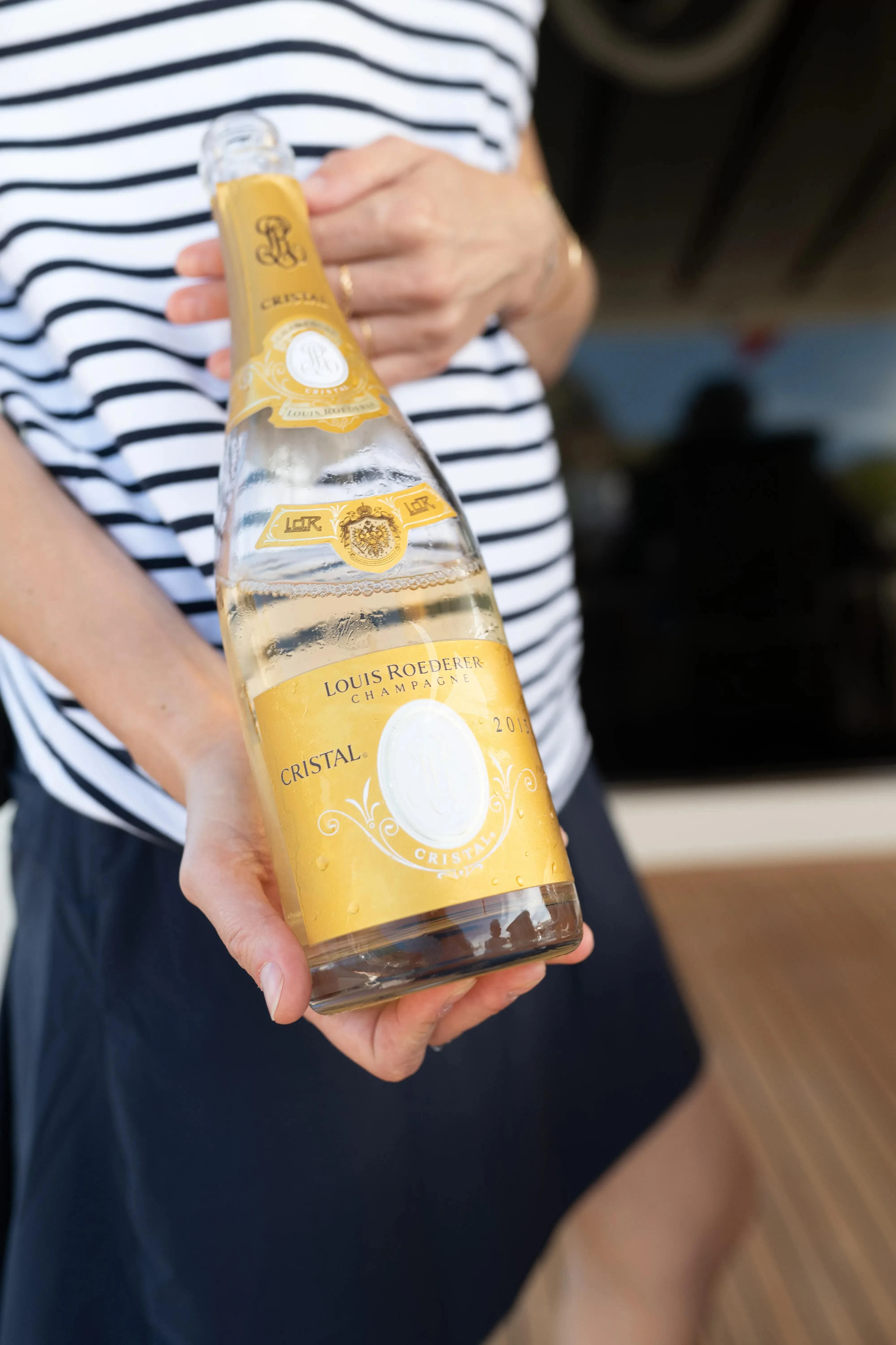 a person holding a bottle aboard JAUNI Yacht for Sale