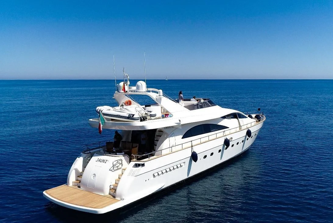 a white yacht in the water aboard JAUNI Yacht for Sale