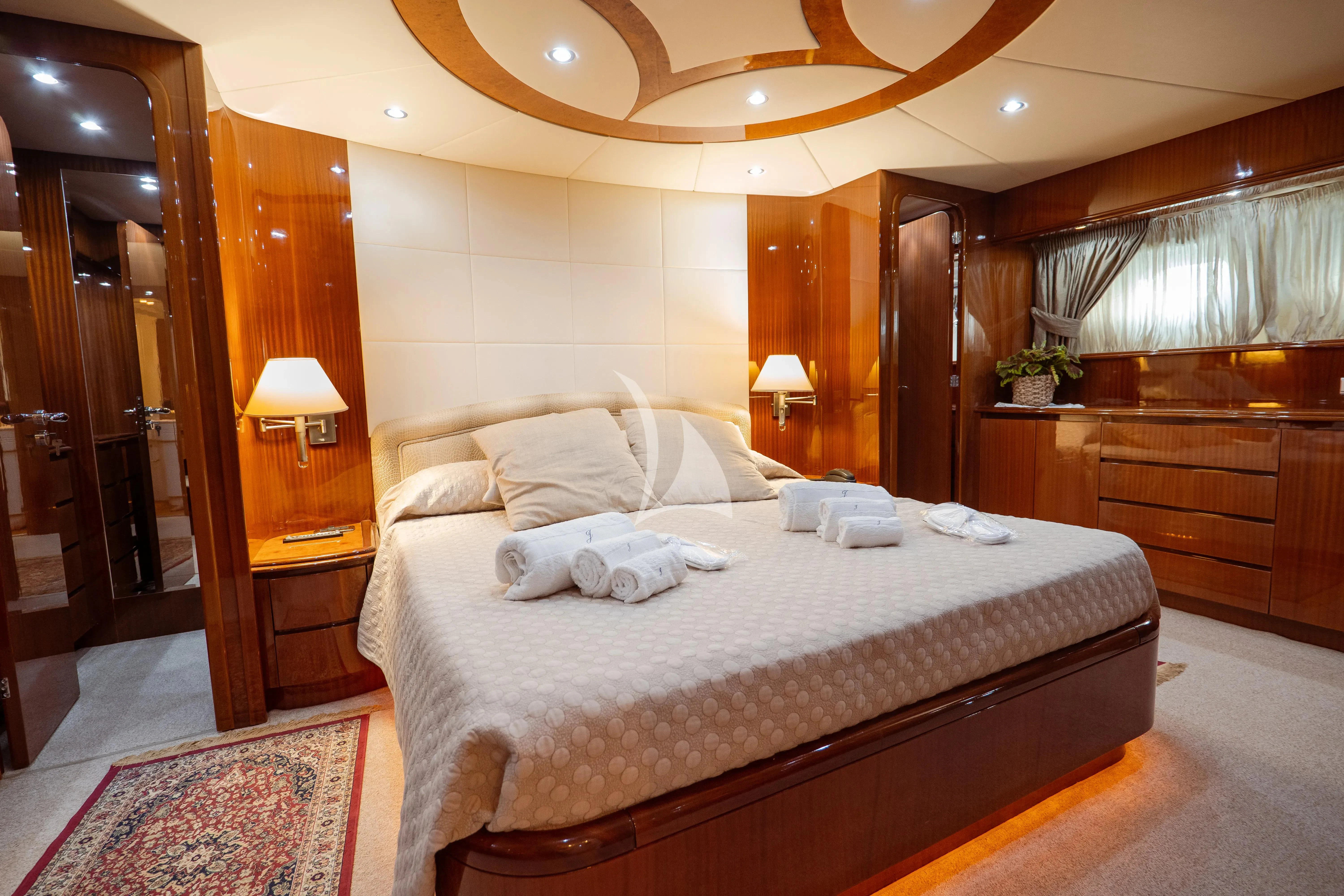 a large bed in a hotel room aboard JAUNI Yacht for Sale