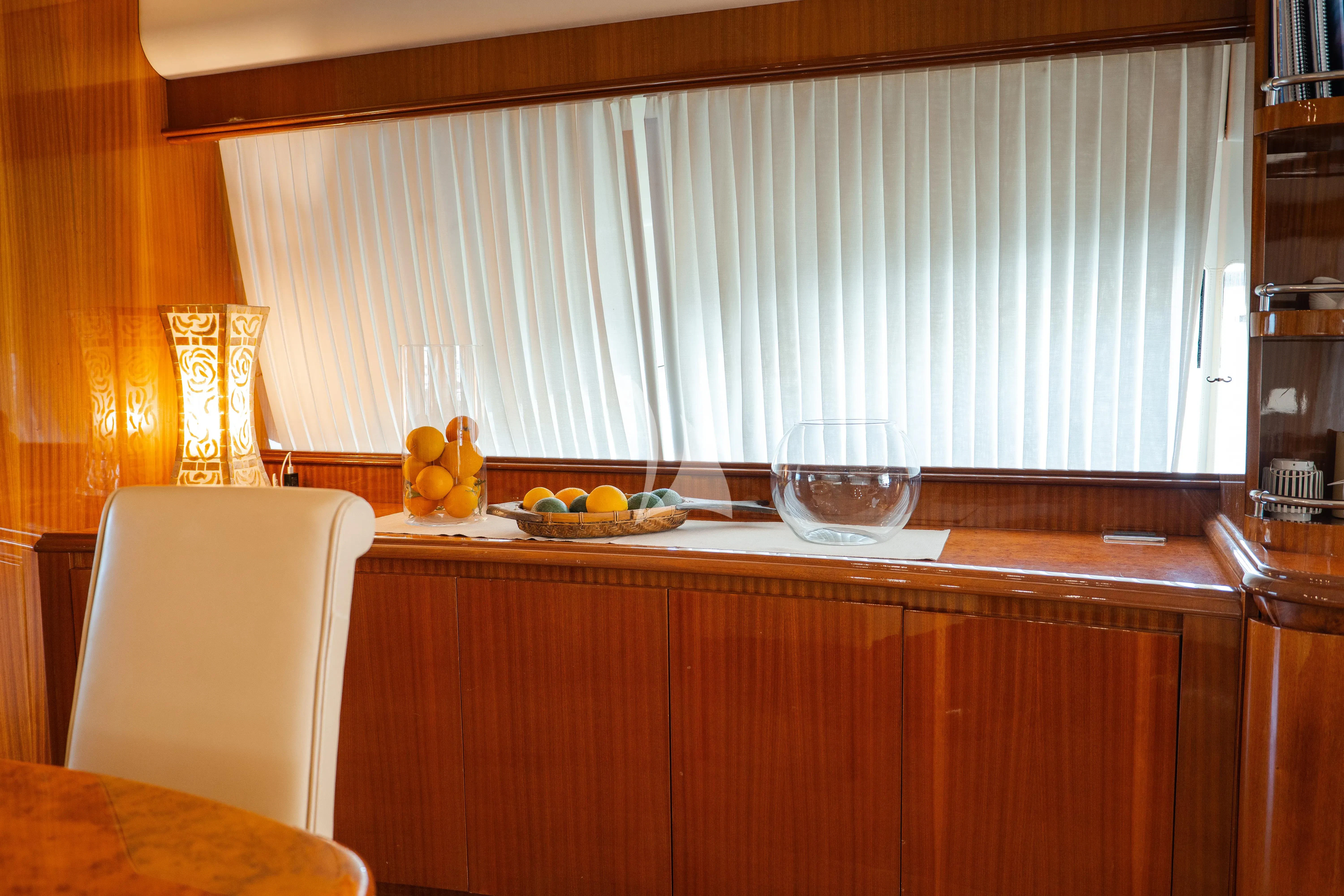 a glass of wine on a table aboard JAUNI Yacht for Sale