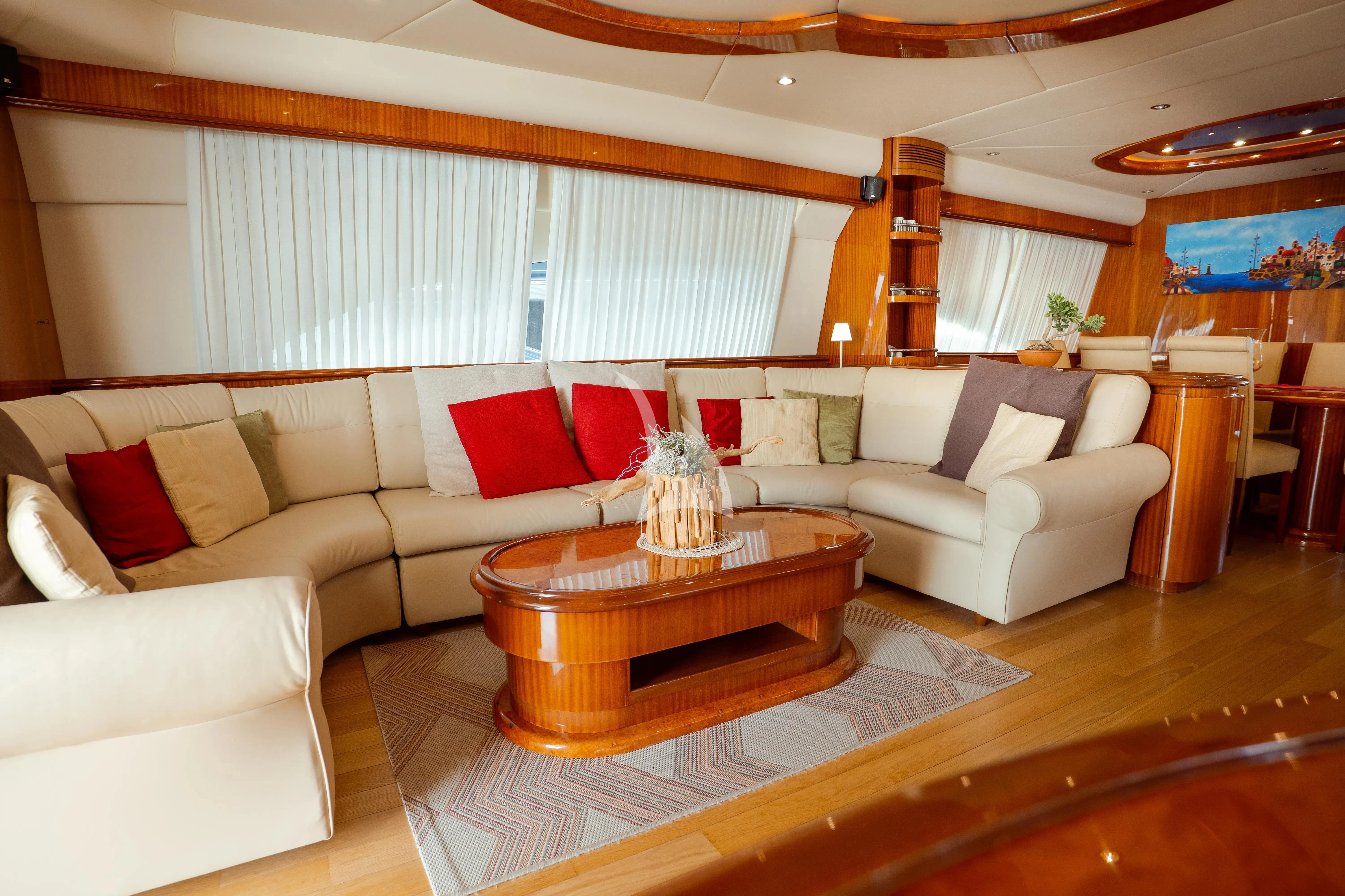 a living room with a couch and a coffee table aboard JAUNI Yacht for Sale