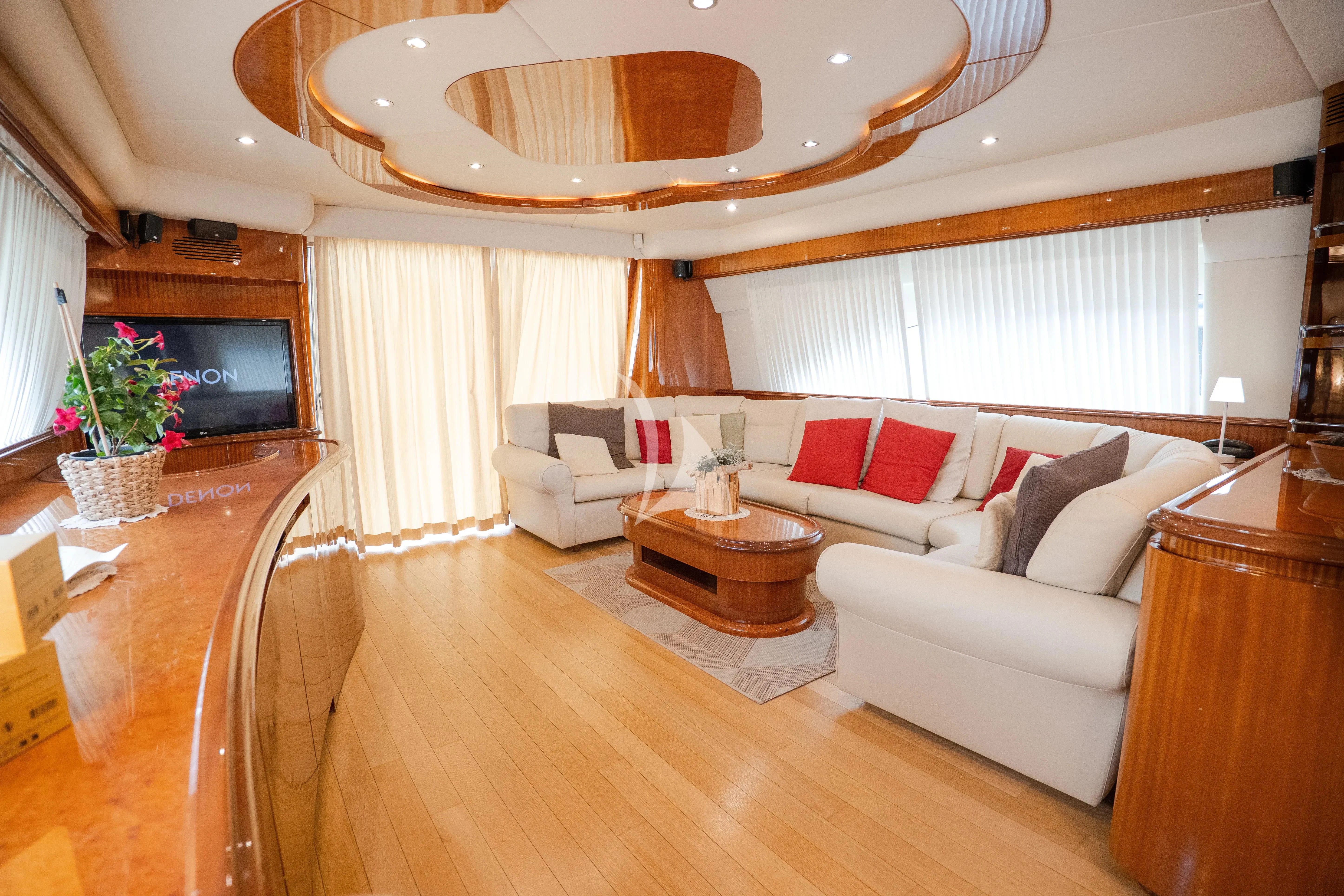 a living room with a large white sofa and a television aboard JAUNI Yacht for Sale