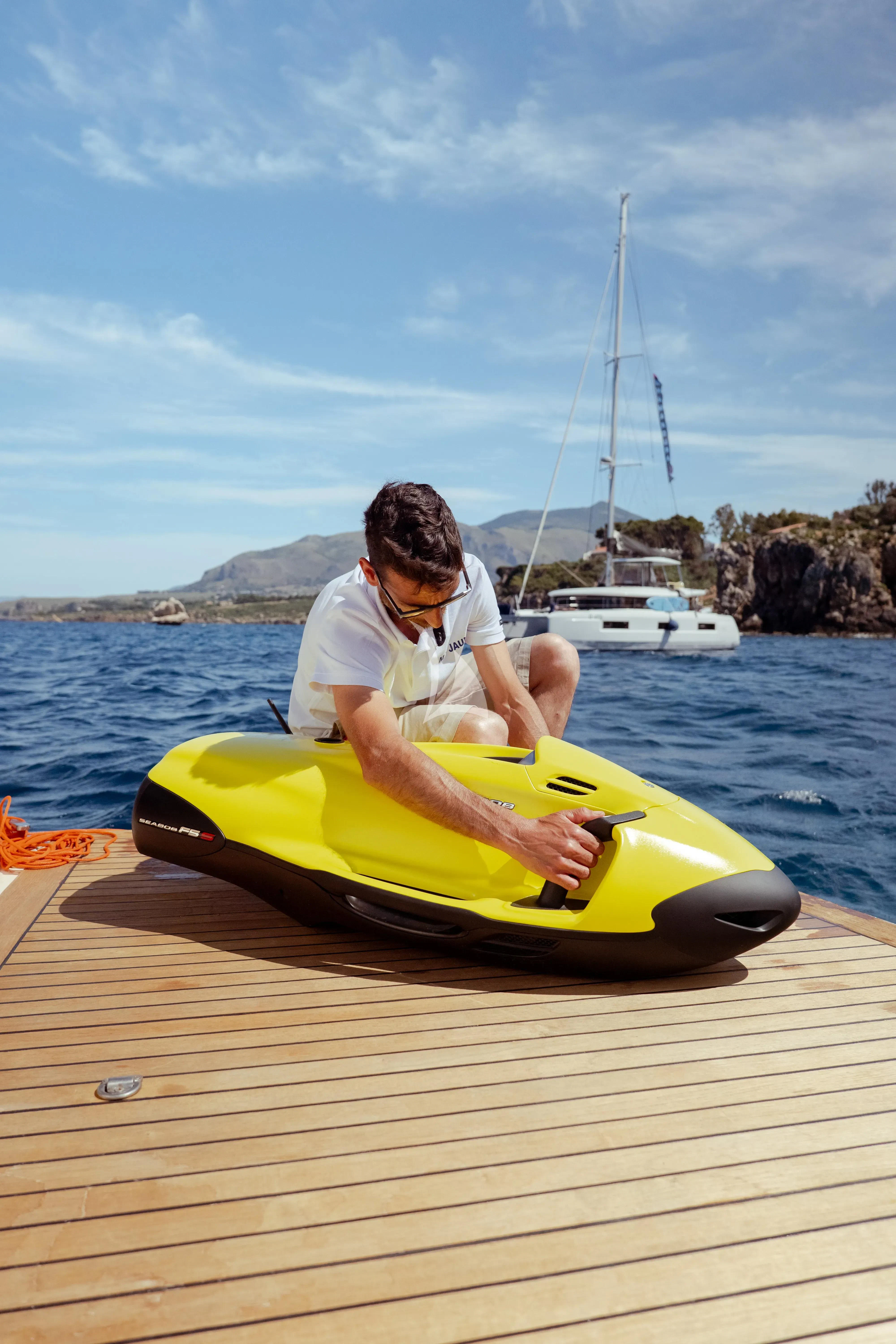 a person on a yellow kayak aboard JAUNI Yacht for Sale