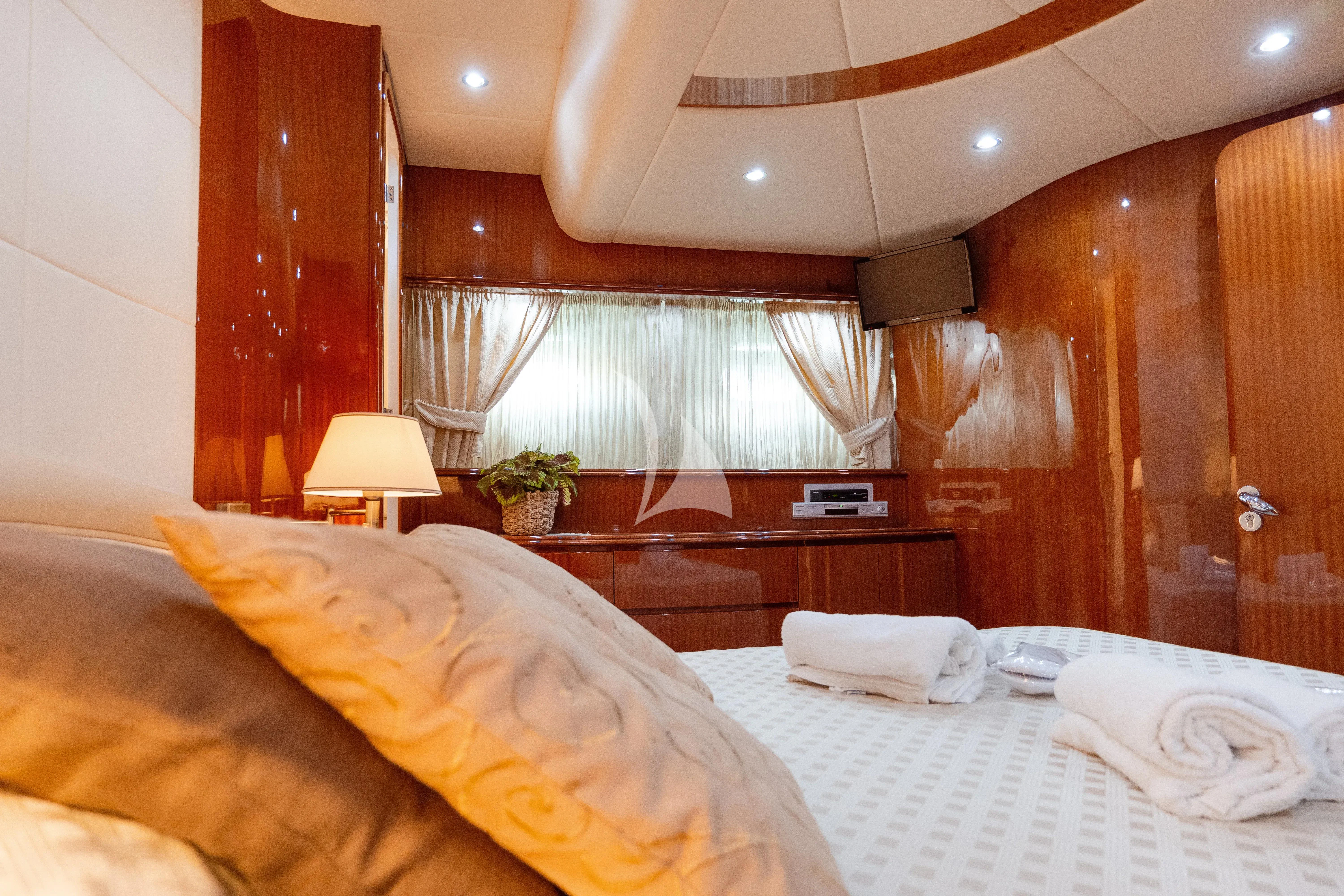 a room with a bed and a lamp aboard JAUNI Yacht for Sale