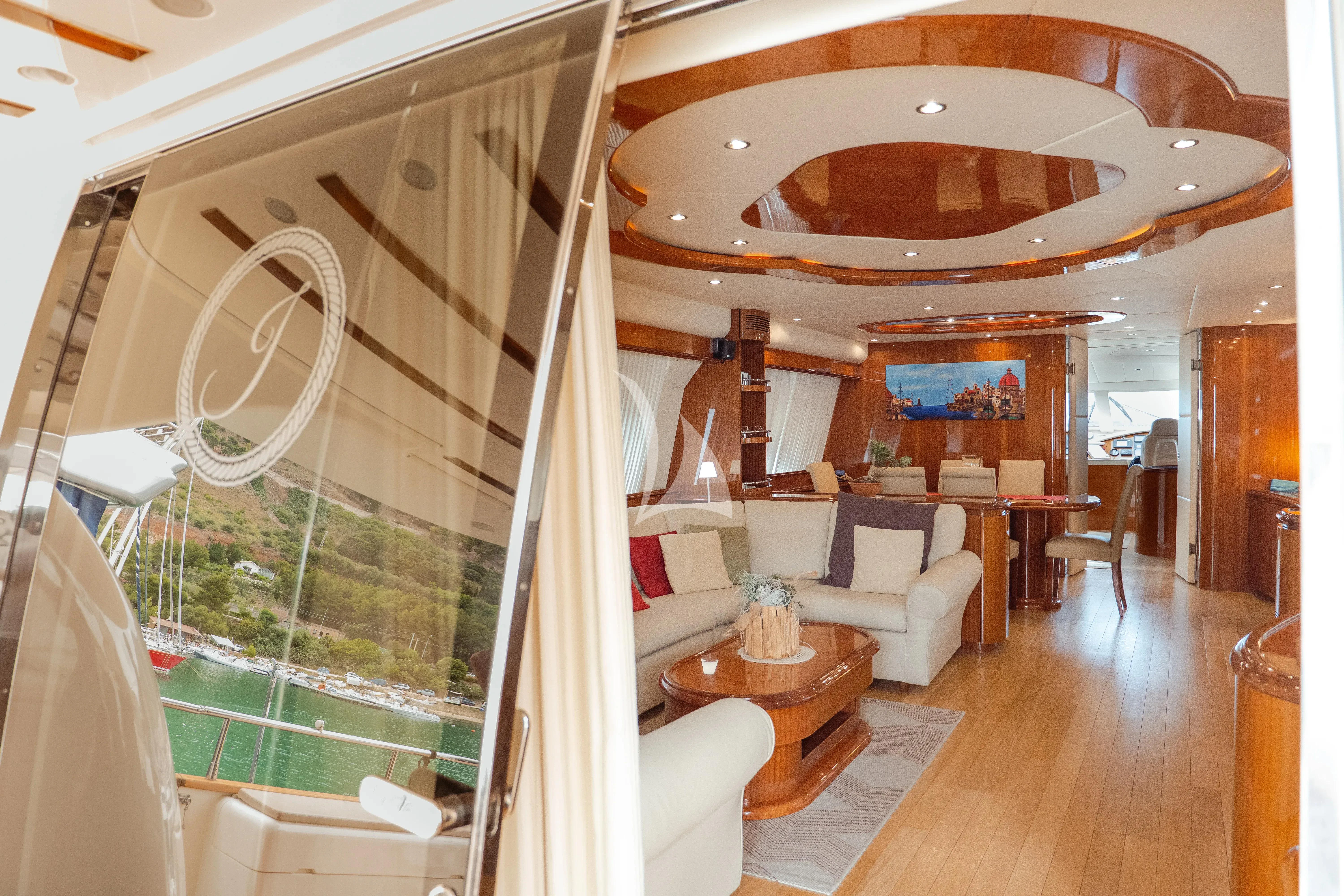 a room with a table and chairs aboard JAUNI Yacht for Sale