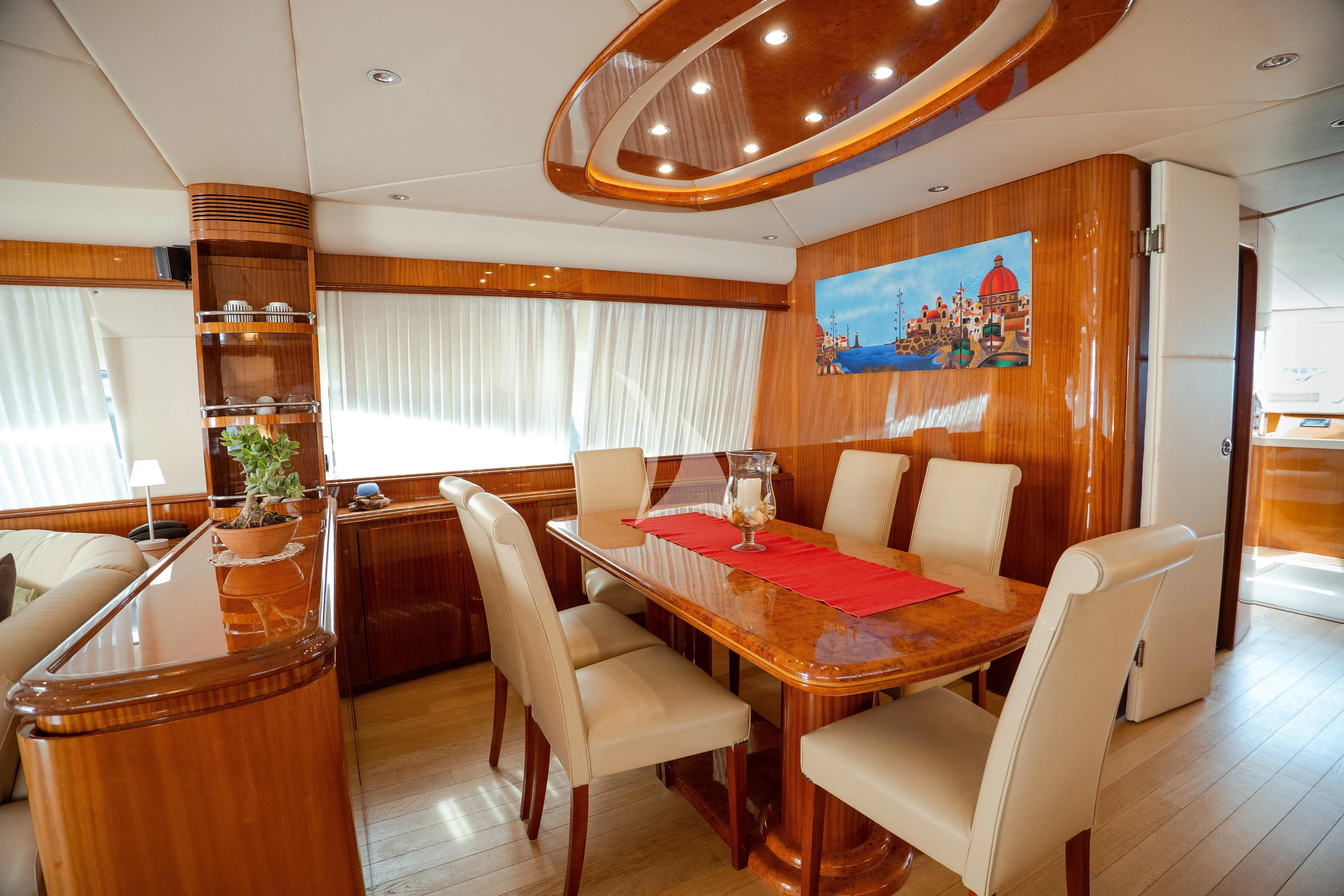 a dining room with a table and chairs aboard JAUNI Yacht for Sale