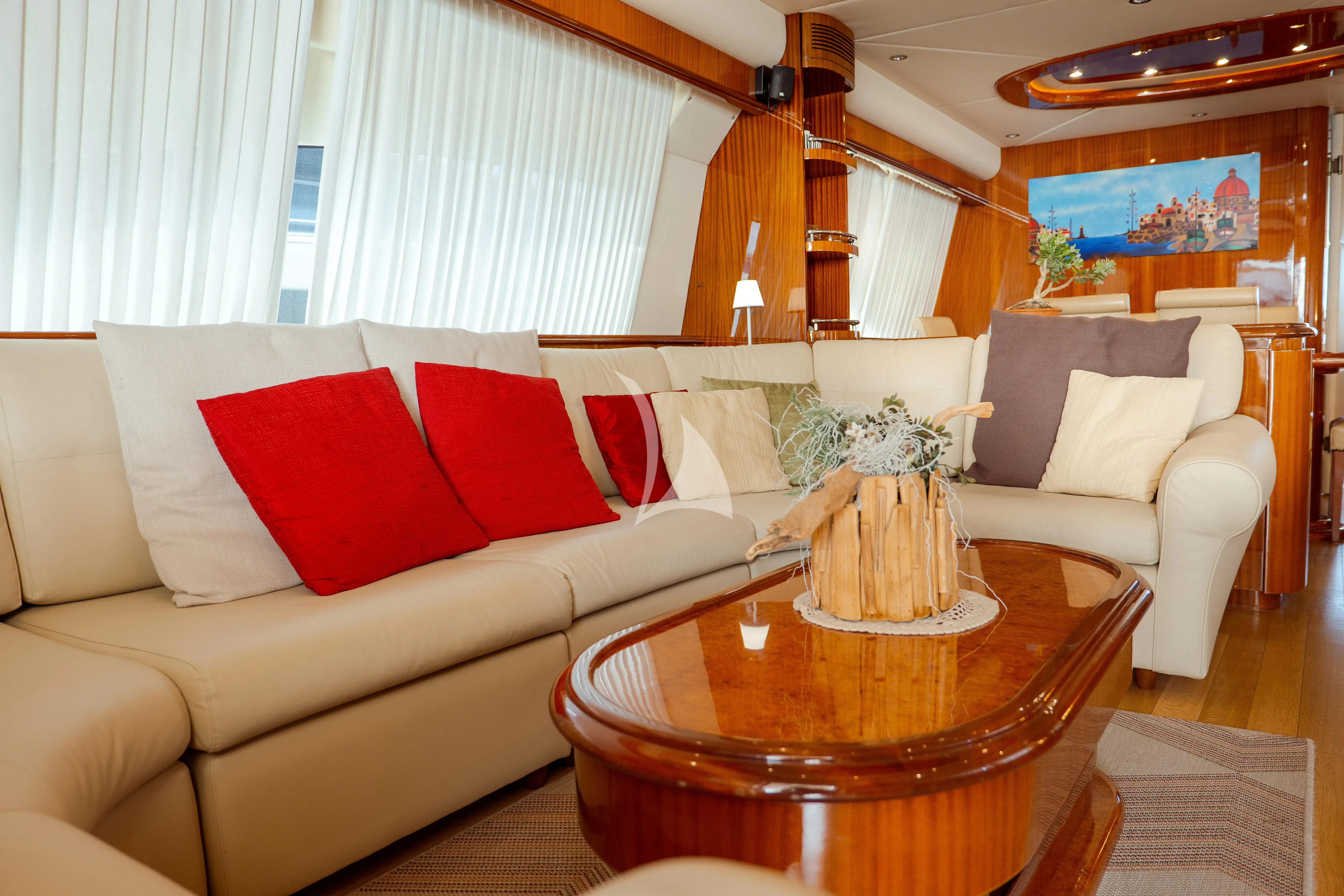 a living room with a table and couches aboard JAUNI Yacht for Sale