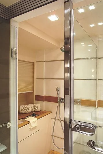 a bathroom with a glass shower aboard RL NOOR Yacht for Sale