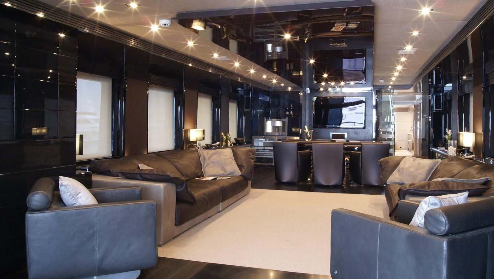 a large living room with a large couch and a large window aboard RL NOOR Yacht for Sale