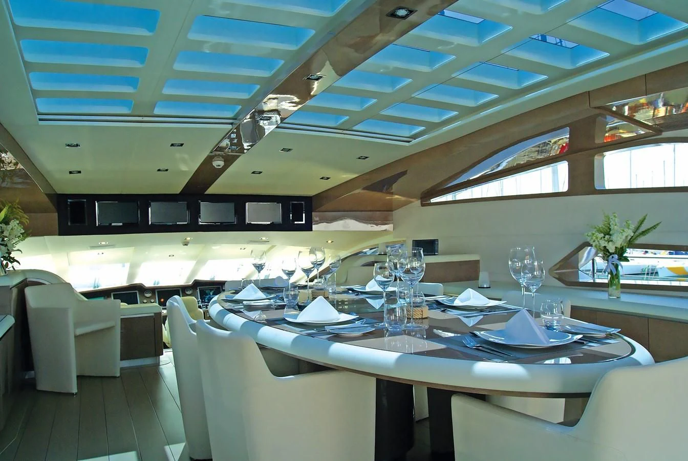 a large room with tables and chairs aboard RL NOOR Yacht for Sale