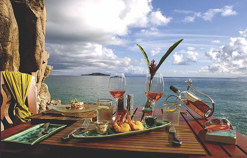 a table with food and wine glasses aboard RL NOOR Yacht for Sale