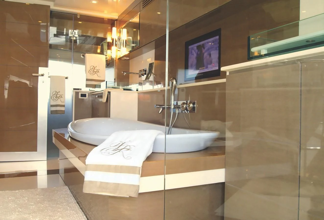 a bathroom with a large glass shower aboard RL NOOR Yacht for Sale