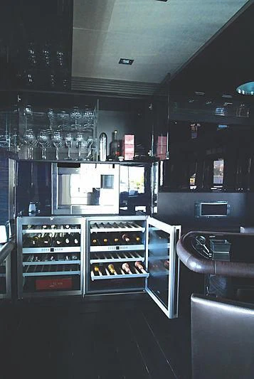 a kitchen with a lot of wine glasses aboard RL NOOR Yacht for Sale