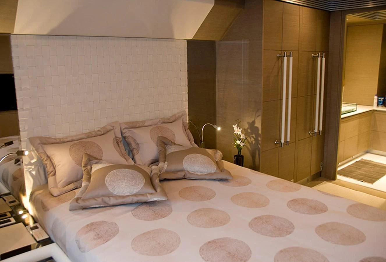 a bed with white sheets and pillows aboard RL NOOR Yacht for Sale