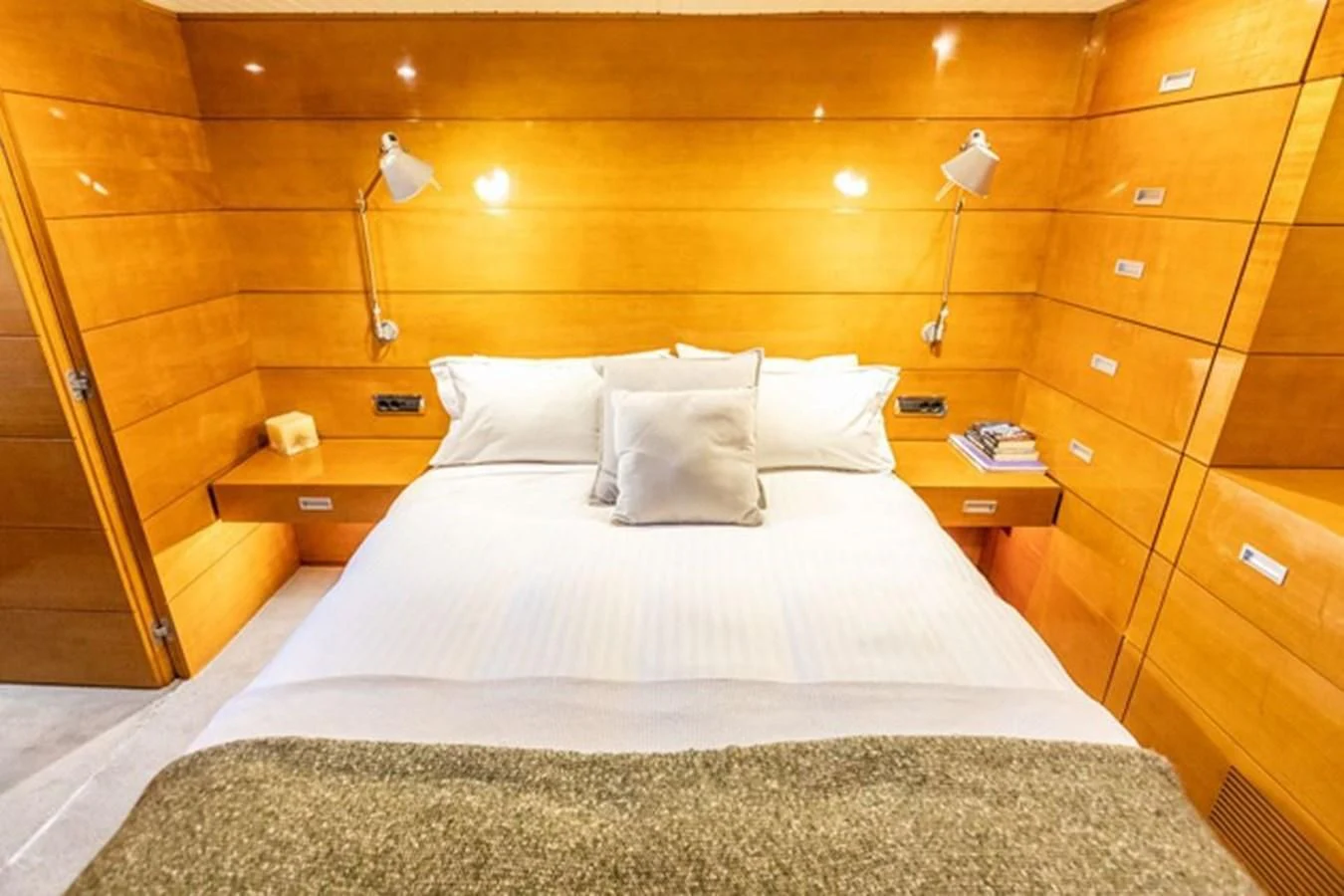 a bed with white sheets and pillows aboard HISTORY Yacht for Sale