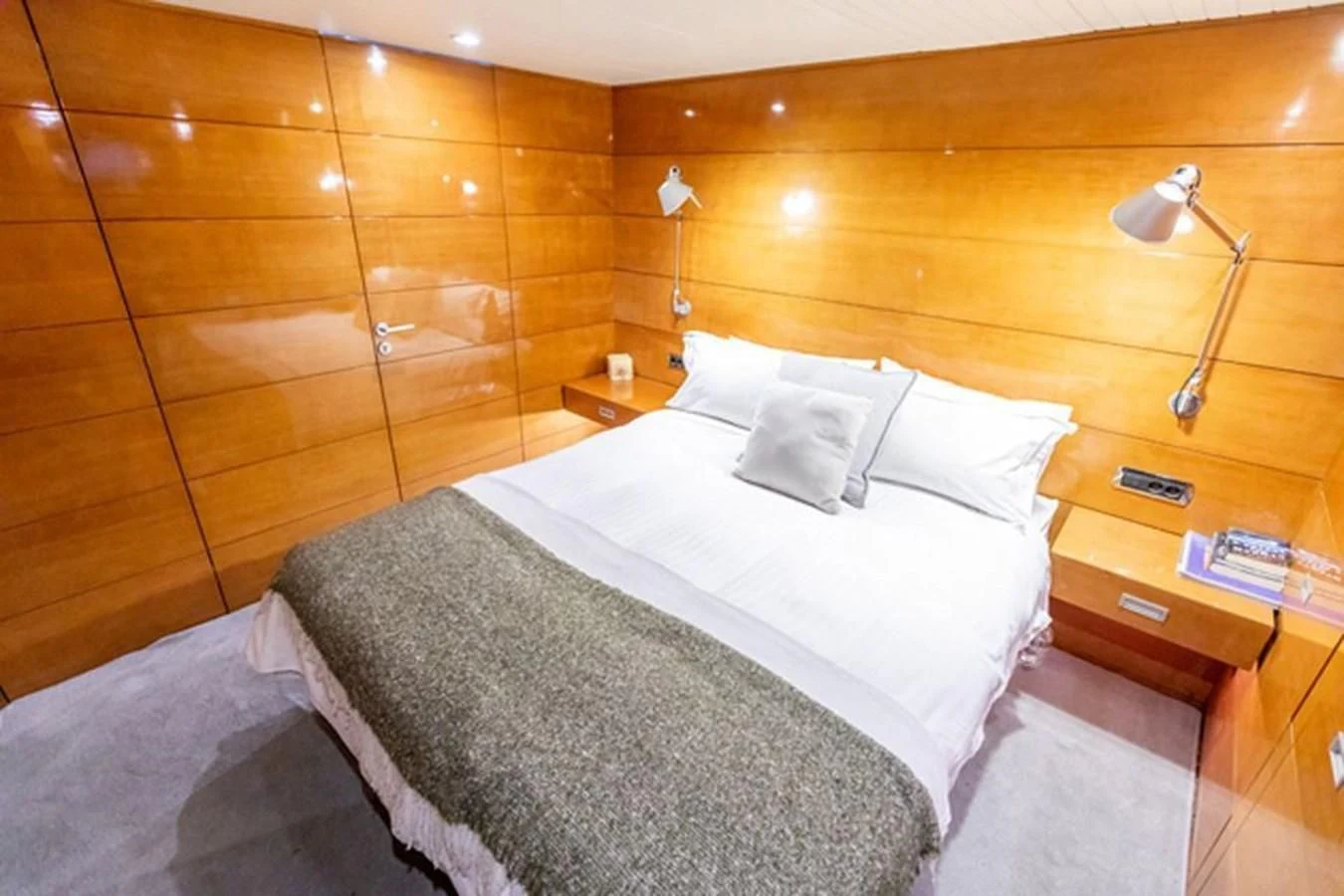 a bed with white sheets aboard HISTORY Yacht for Sale