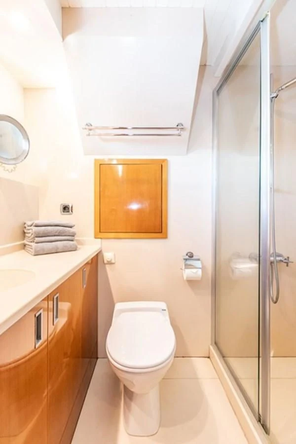 a bathroom with a toilet and a sink aboard HISTORY Yacht for Sale