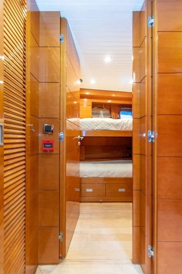 a closet with a bed and a door aboard HISTORY Yacht for Sale