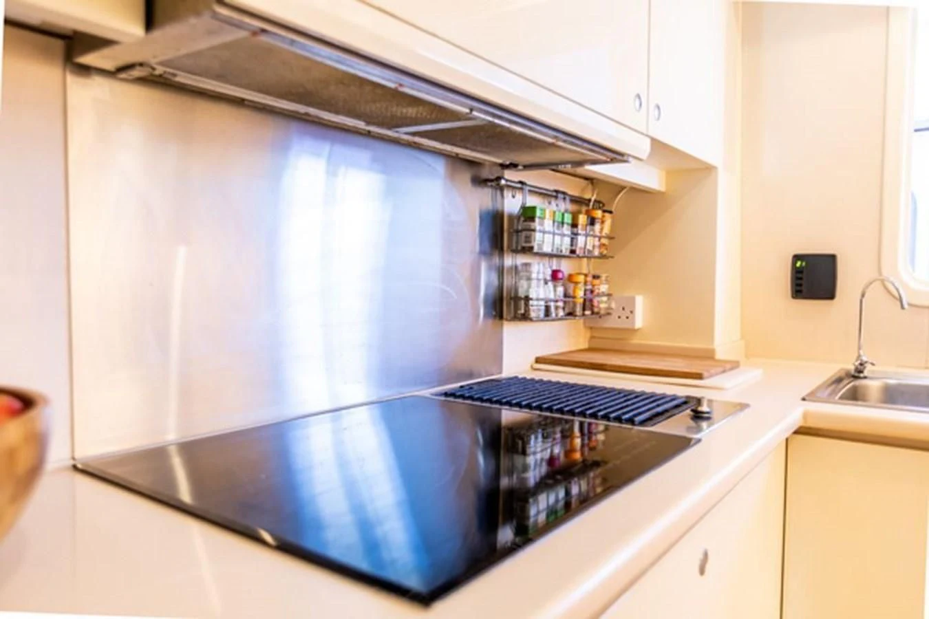 a large silver refrigerator with a shelf of food on the side aboard HISTORY Yacht for Sale