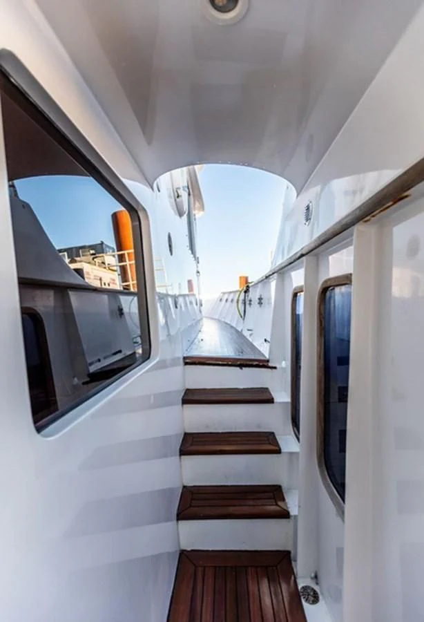 a white vehicle with a wooden staircase aboard HISTORY Yacht for Sale