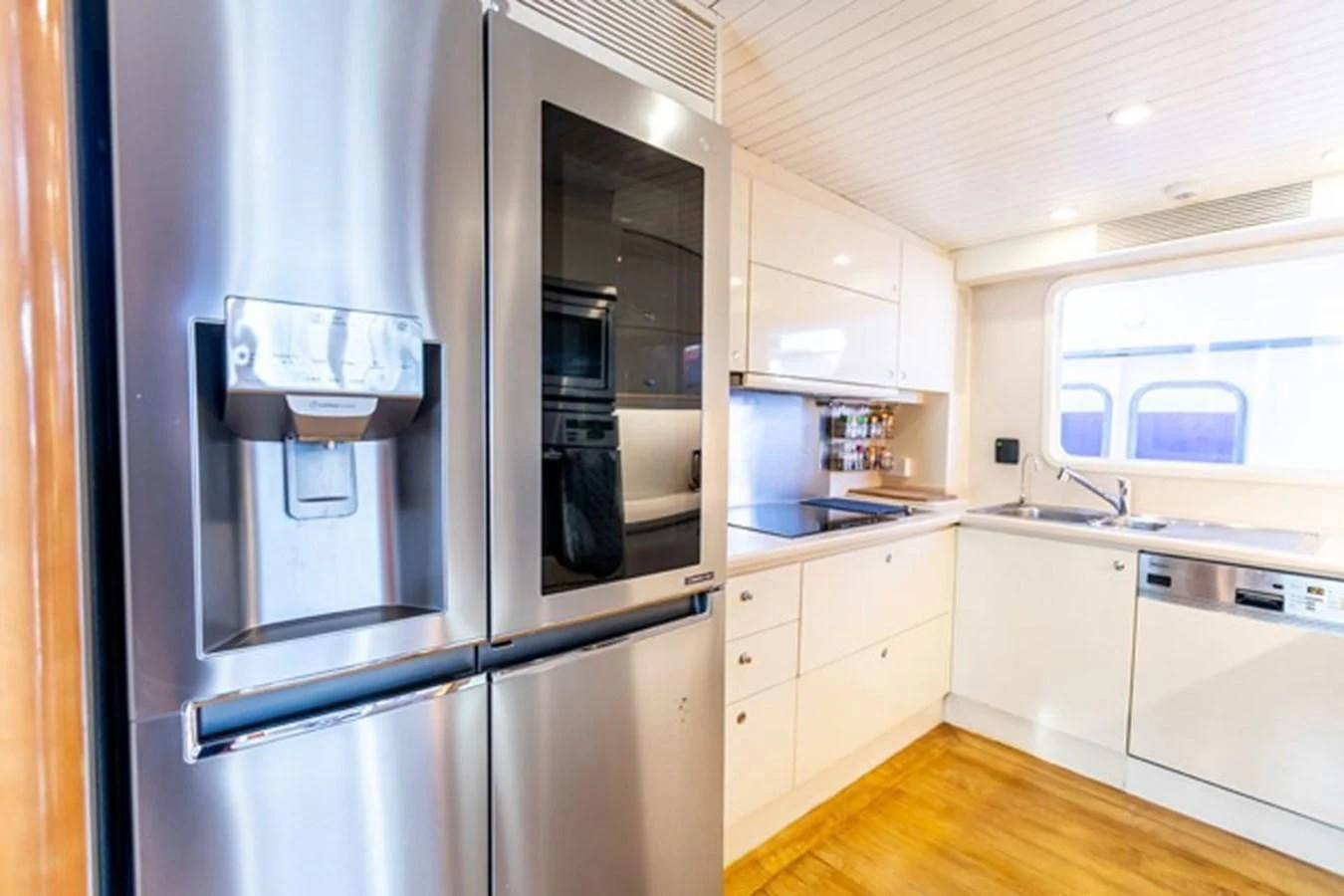 a kitchen with a stainless steel refrigerator aboard HISTORY Yacht for Sale