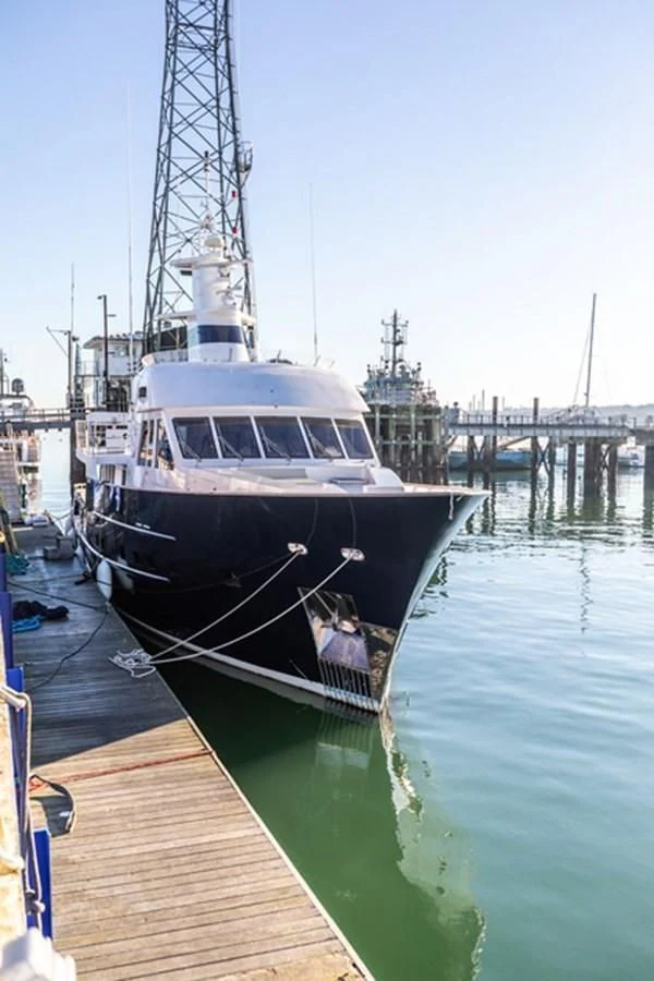 a boat docked at a pier aboard HISTORY Yacht for Sale