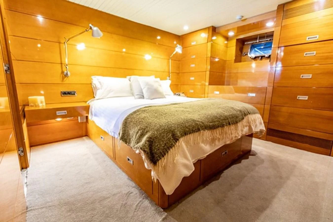 a bedroom with a bed and a dresser aboard HISTORY Yacht for Sale
