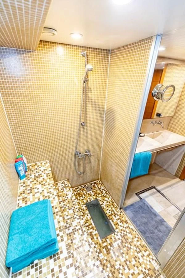 a bathroom with a shower and a sink aboard HISTORY Yacht for Sale