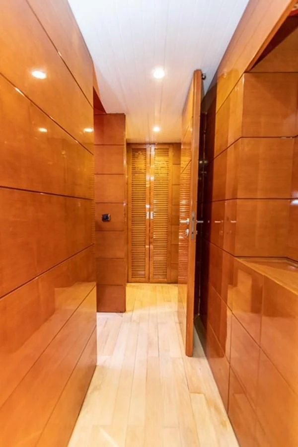 a room with wooden walls and wooden floors aboard HISTORY Yacht for Sale