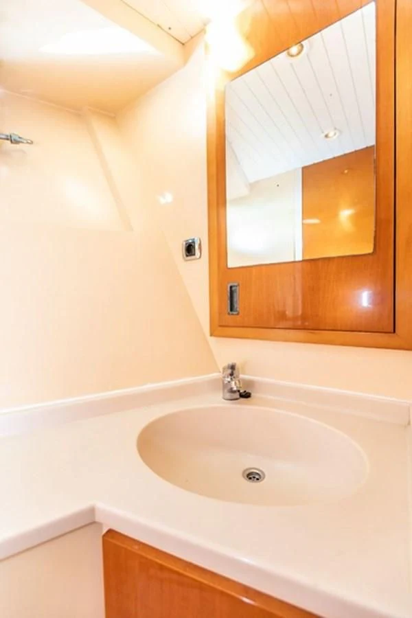 a bathroom sink with a mirror aboard HISTORY Yacht for Sale