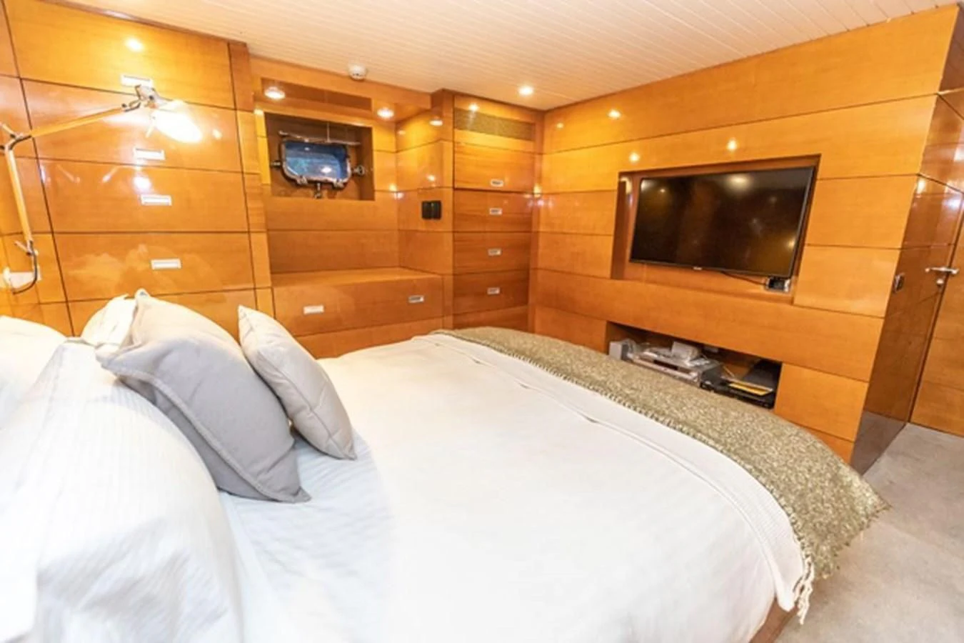 a bed with a television on top of it aboard HISTORY Yacht for Sale