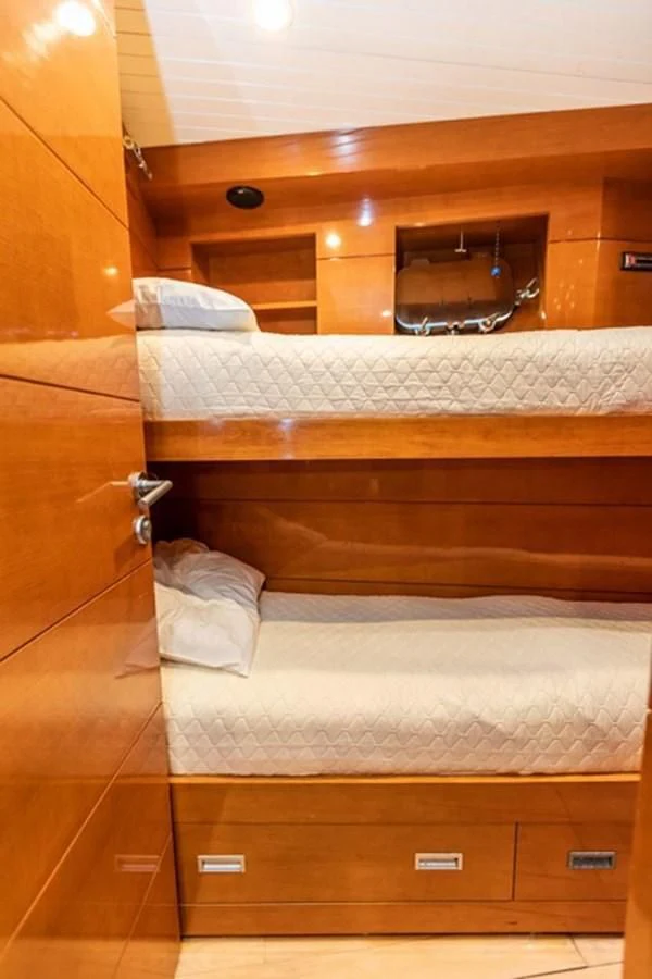 a bed with a mirror above it aboard HISTORY Yacht for Sale