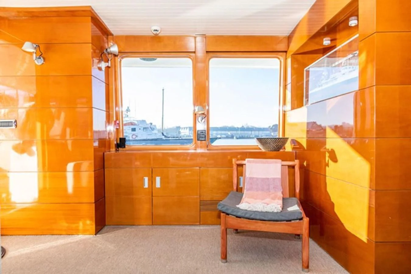 a room with a chair and a bench aboard HISTORY Yacht for Sale