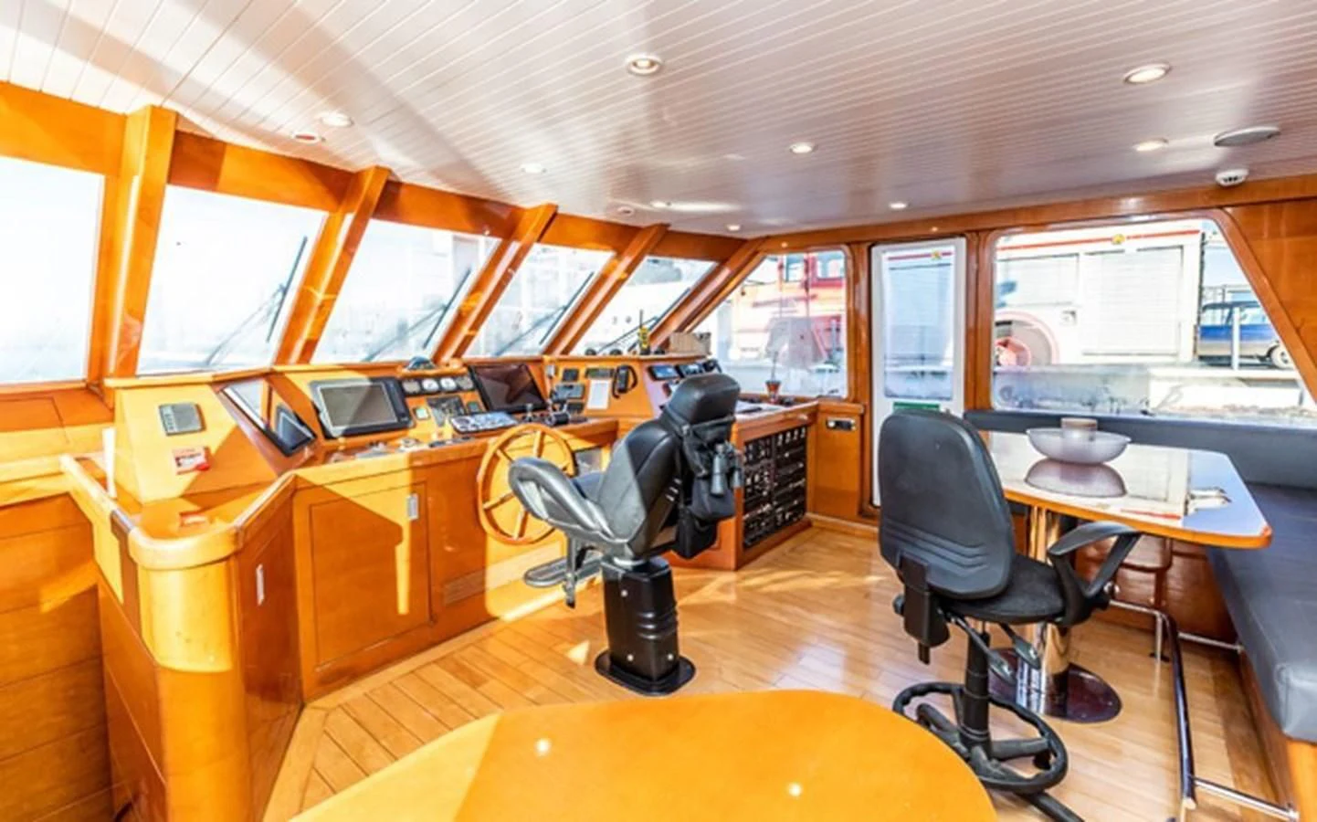 a room with a table and chairs aboard HISTORY Yacht for Sale