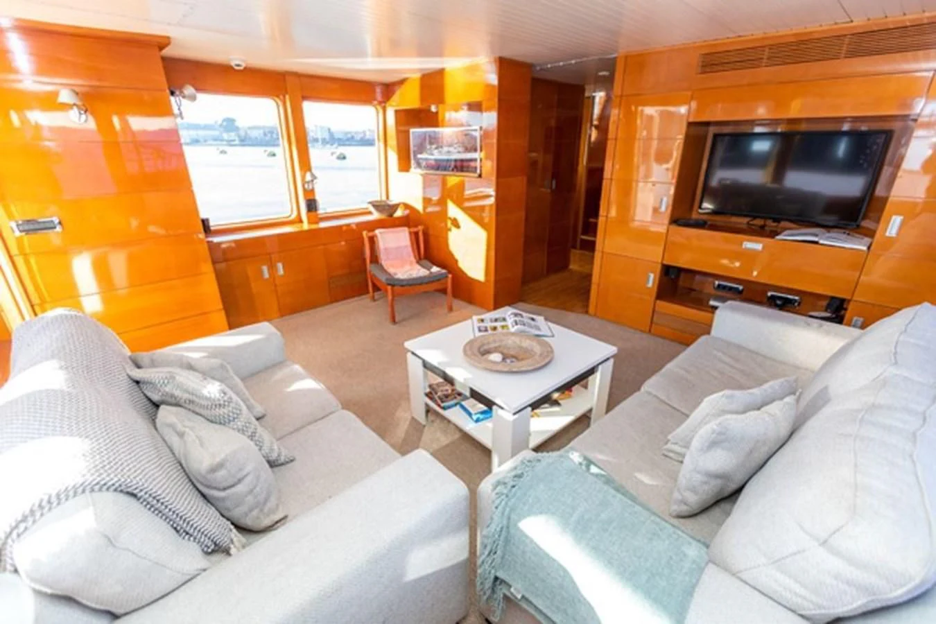 a living room with a couch and a television aboard HISTORY Yacht for Sale