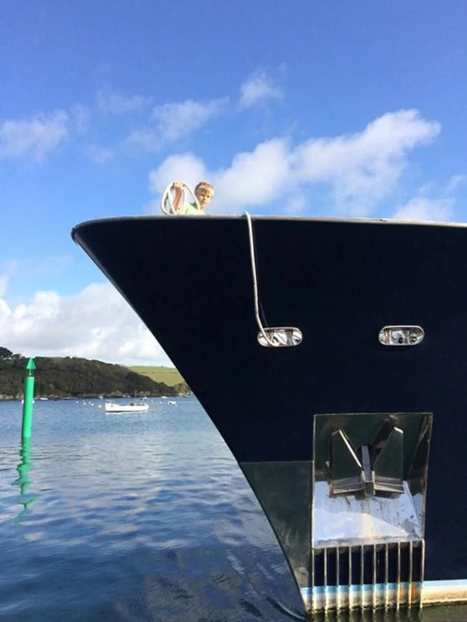a person jumping out of a boat aboard HISTORY Yacht for Sale