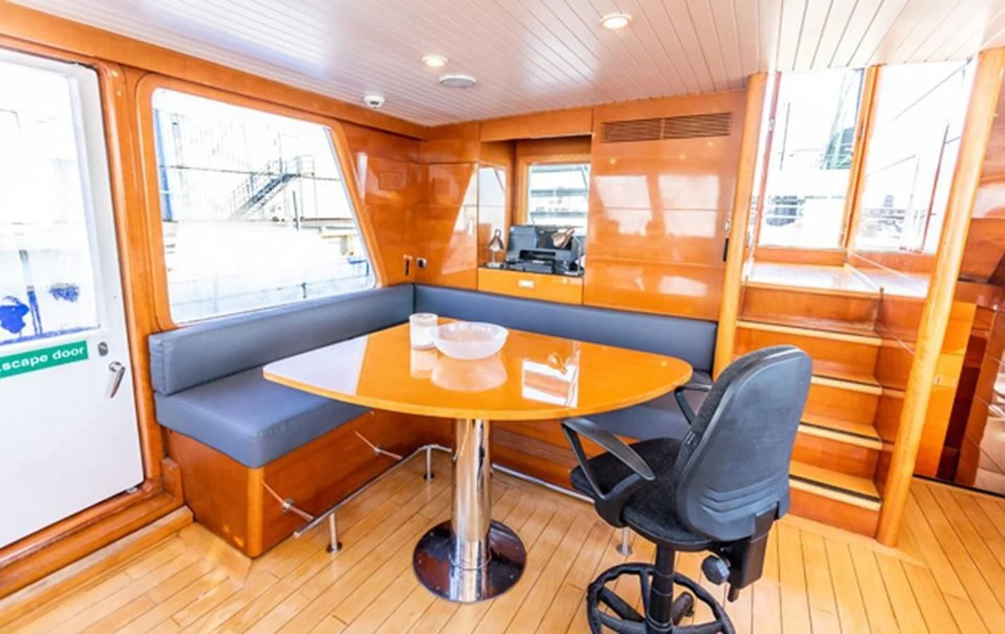 a room with a table and chairs aboard HISTORY Yacht for Sale