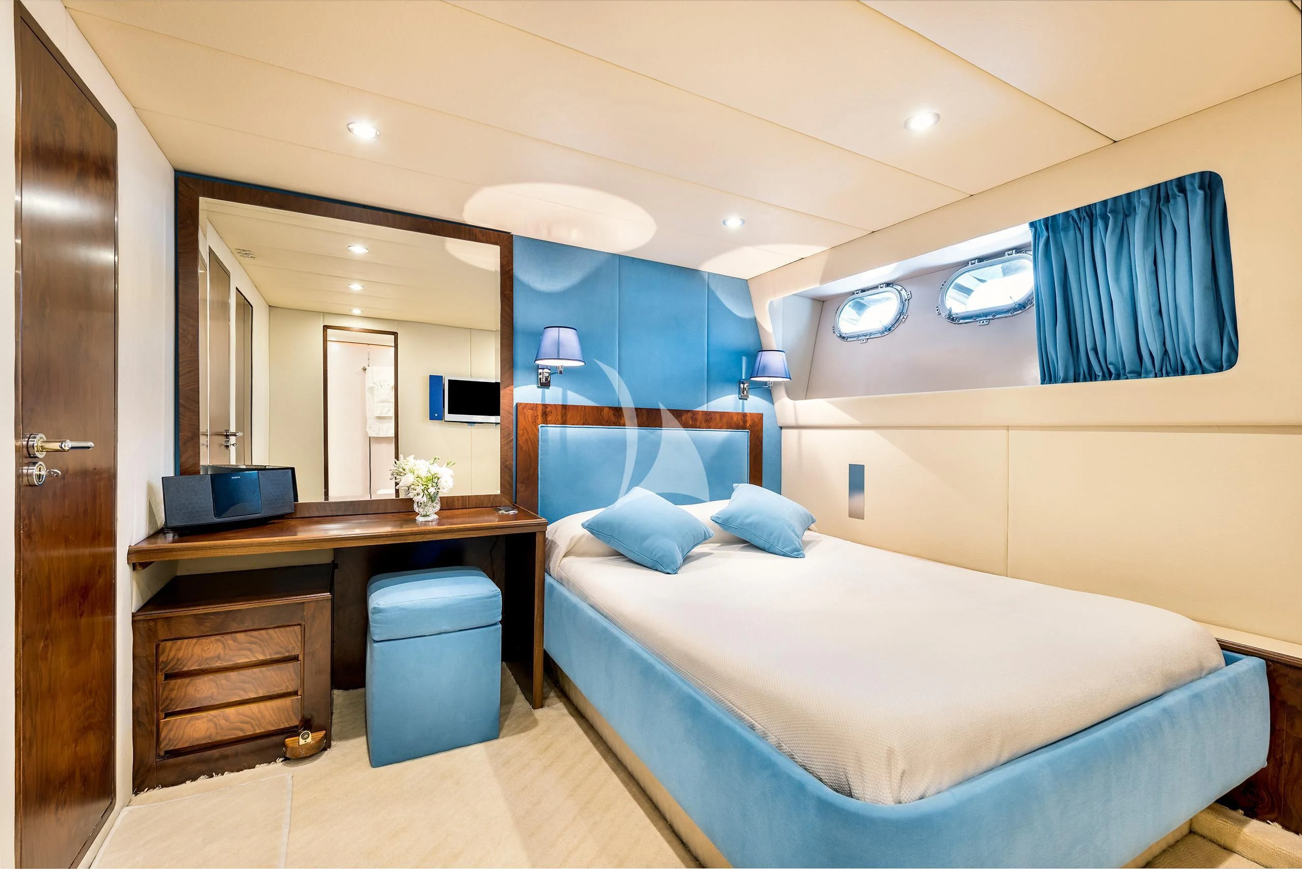 a room with a bed and desk aboard ANTISAN Yacht for Charter