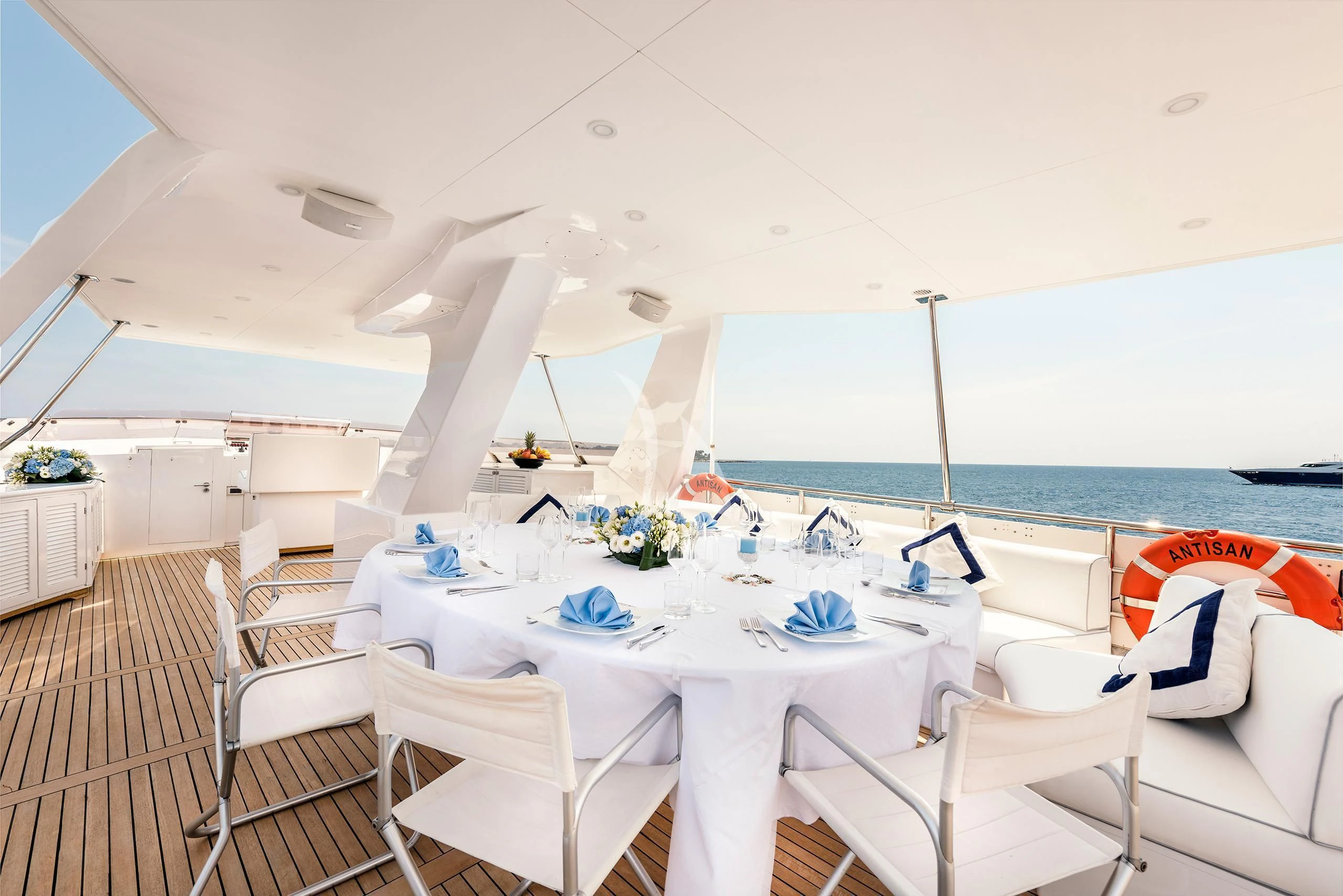a table set for a dinner on a boat aboard ANTISAN Yacht for Charter